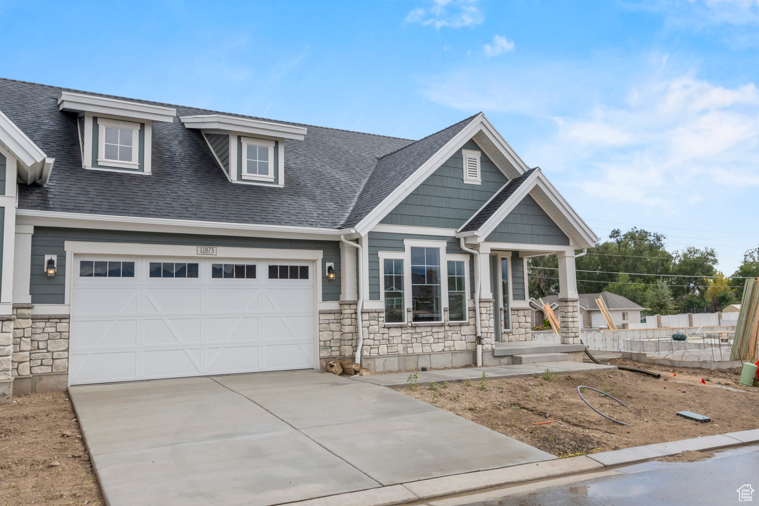 Craftsman-style home featuring a garage and covered porch