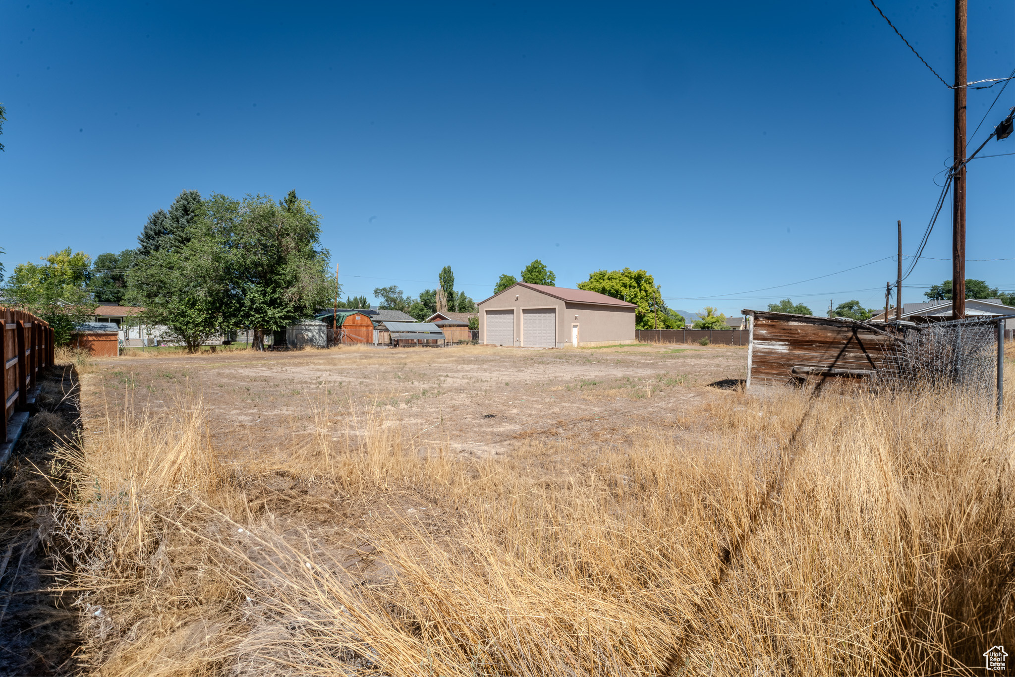 View of yard featuring a garage and an outdoor structure