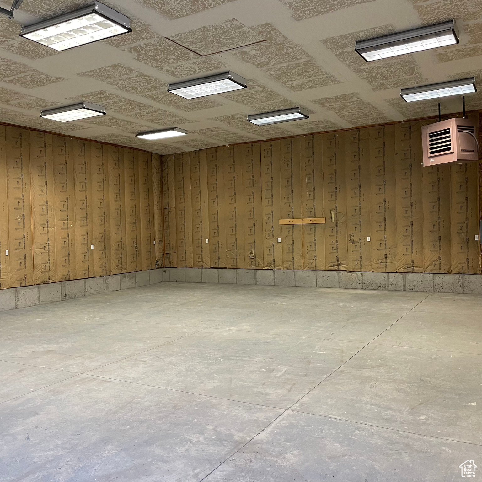 Interior space with an AC wall unit and wooden walls