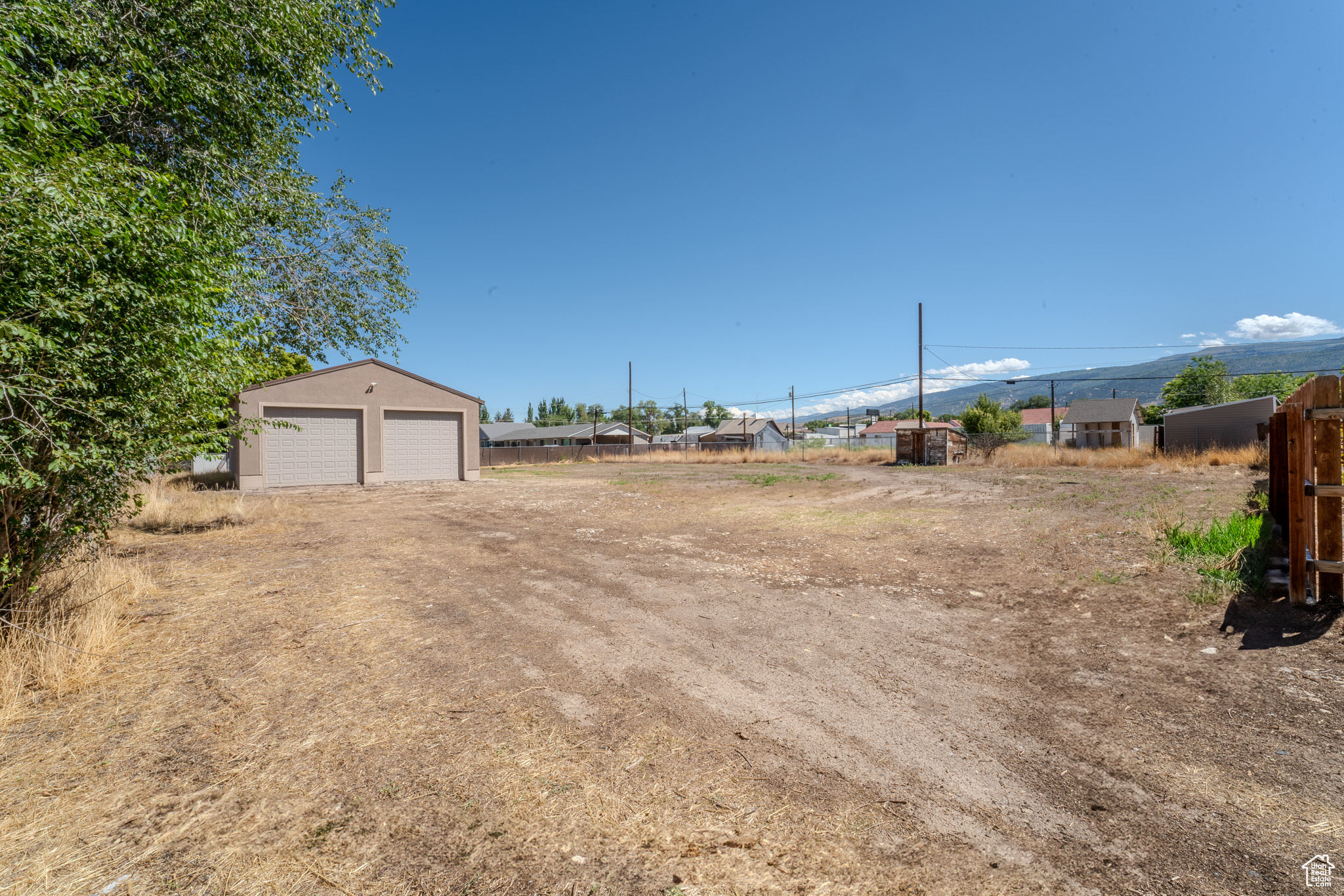 View of yard featuring an outbuilding and a garage