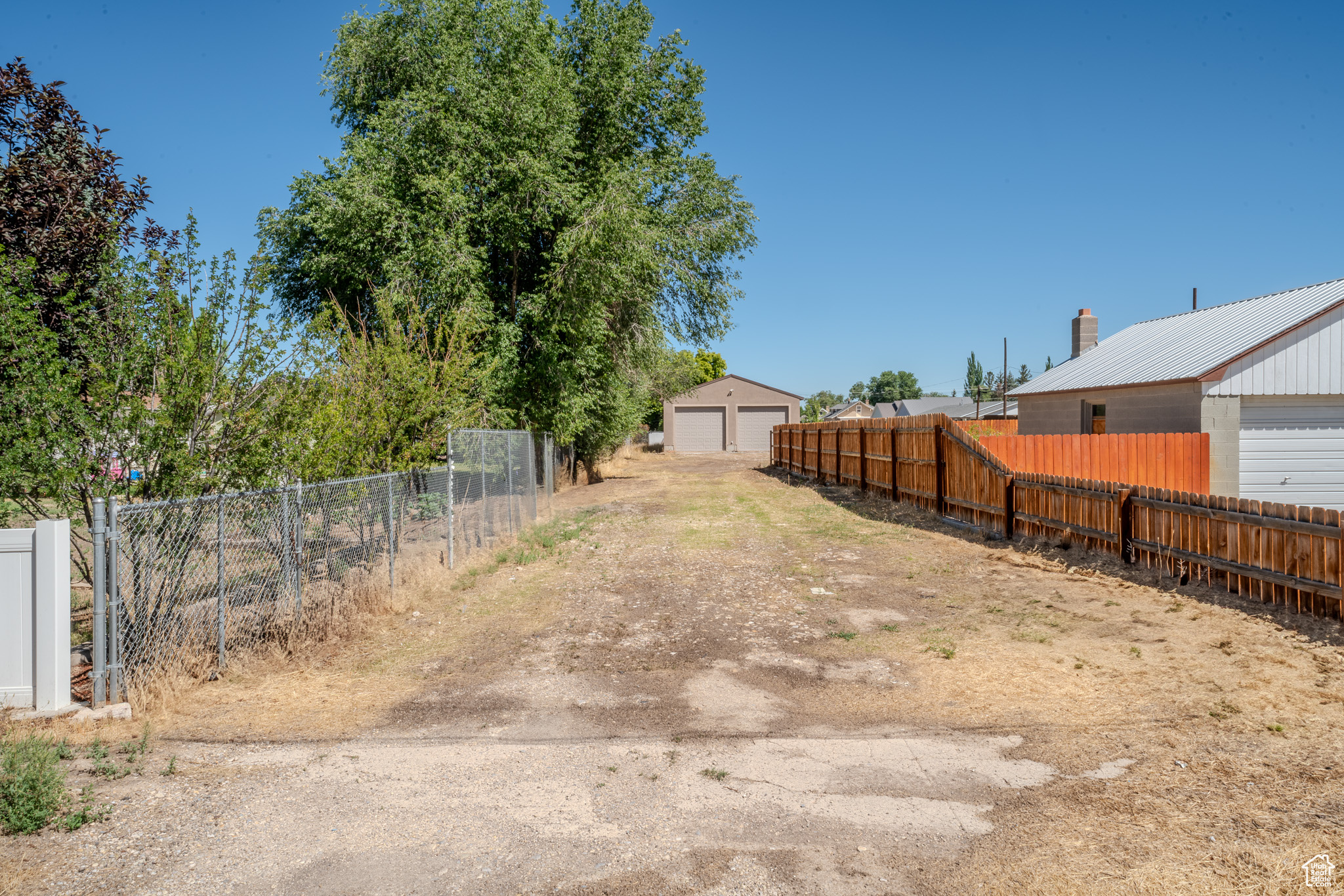 View of yard with a garage and an outbuilding