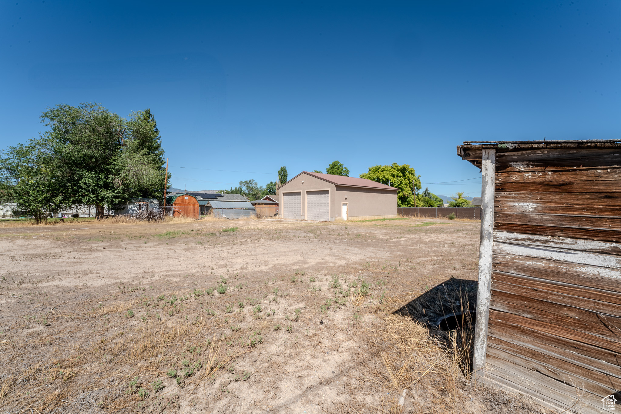 View of yard featuring an outbuilding and a garage