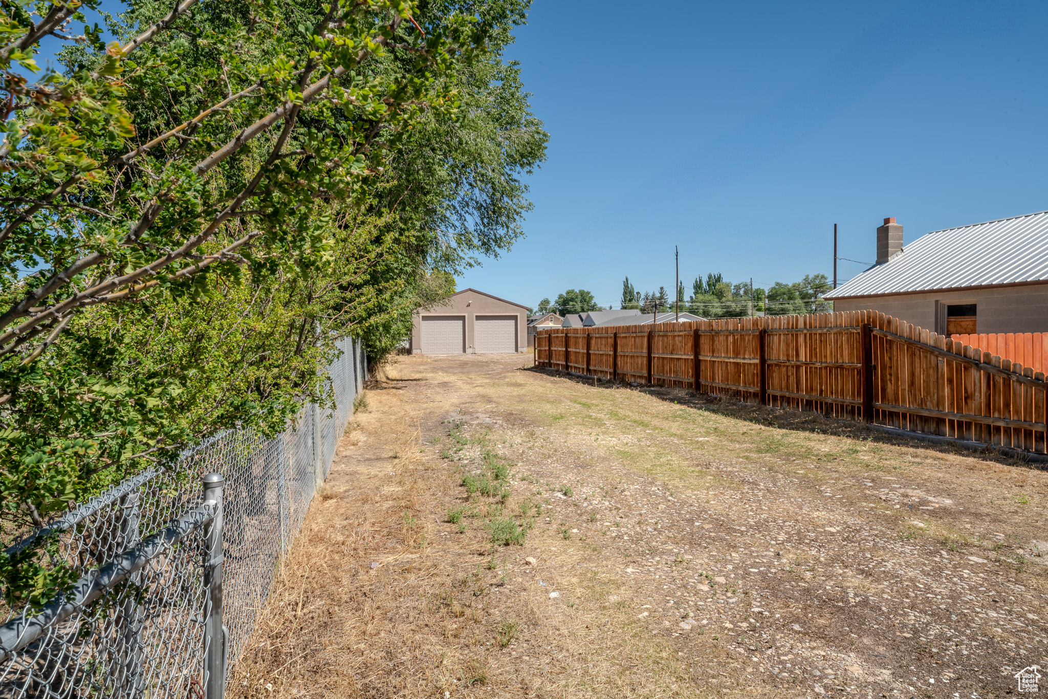 View of yard with an outbuilding and a garage