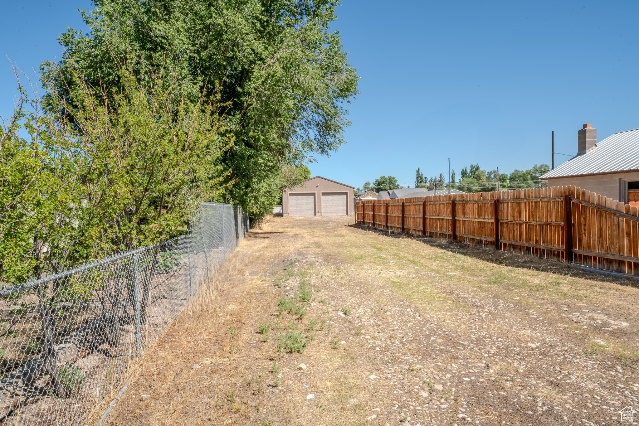 View of yard with an outbuilding and a garage