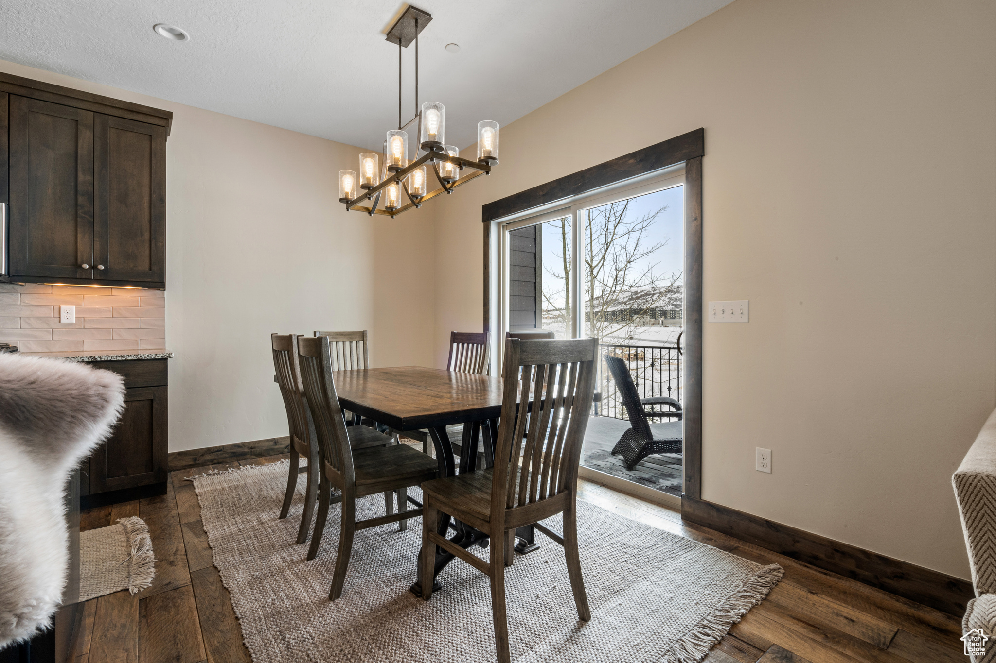 Dining space with dark hardwood / wood-style floors and a chandelier