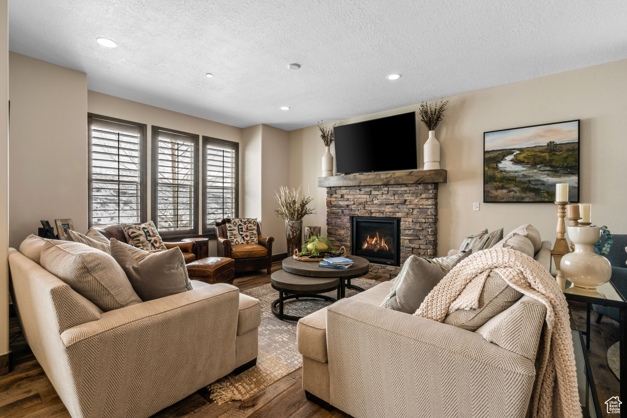 Living room featuring a fireplace, dark hardwood / wood-style flooring, and a textured ceiling