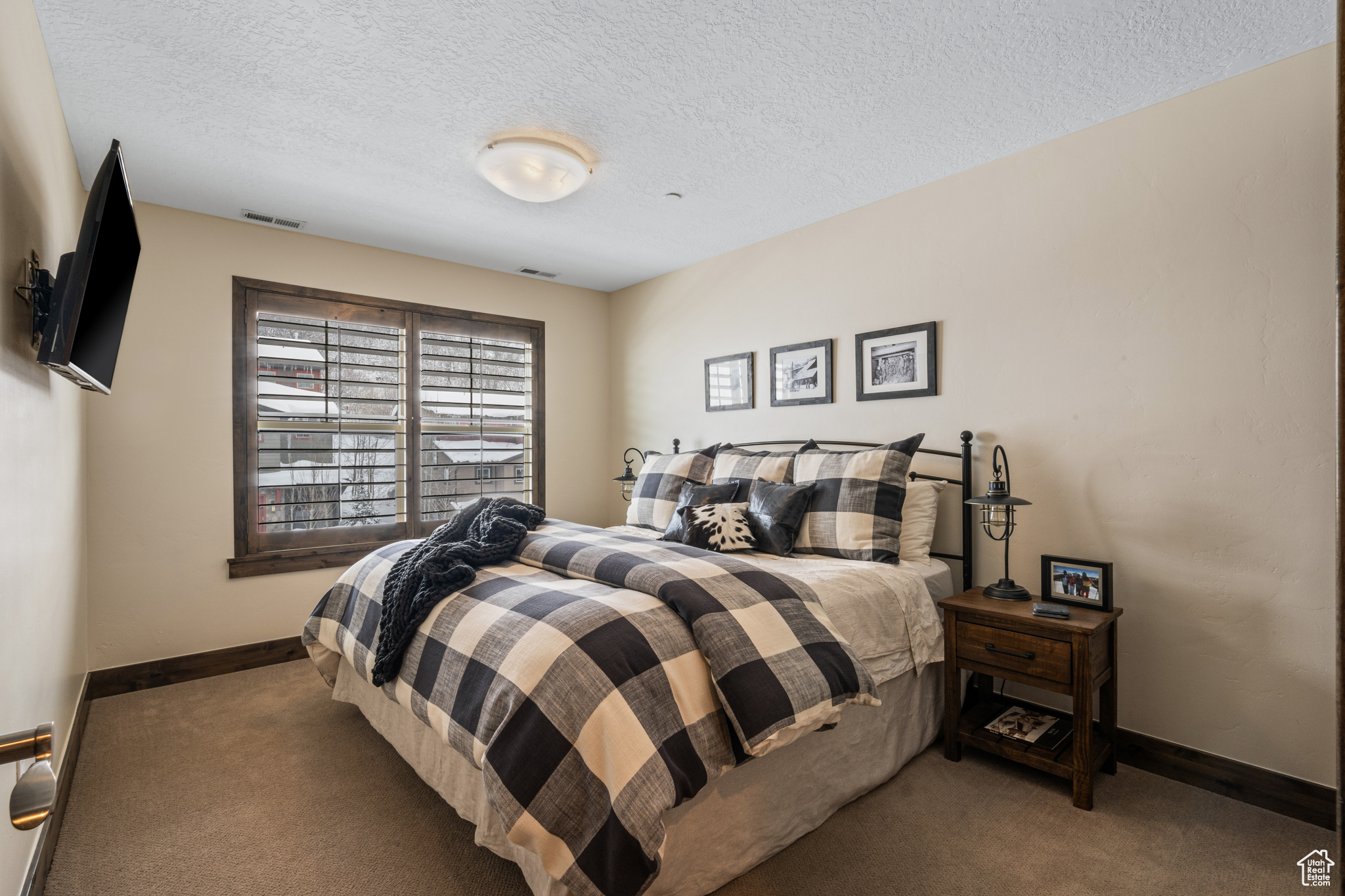 Carpeted bedroom with a textured ceiling