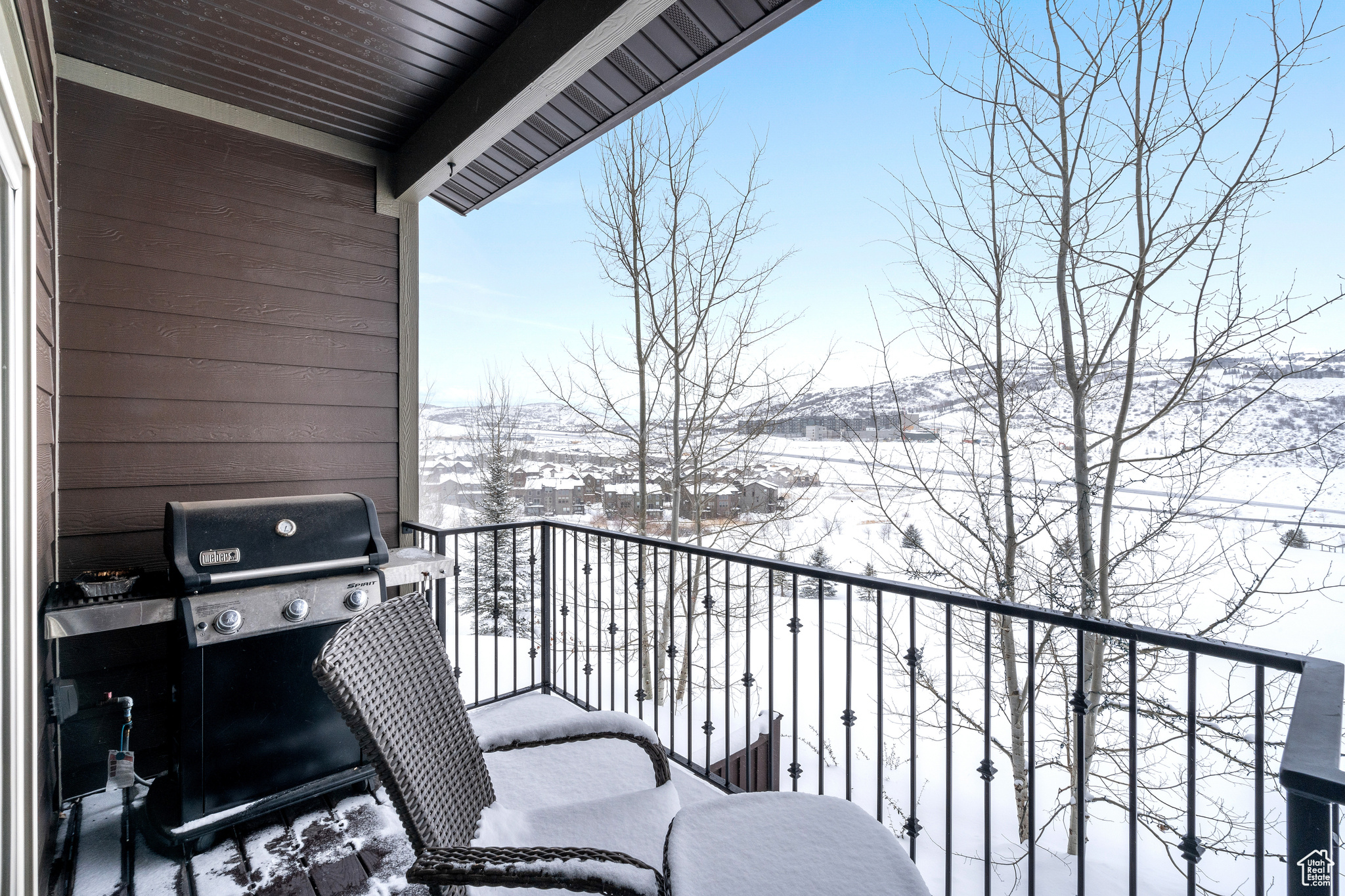 View of snow covered back of property