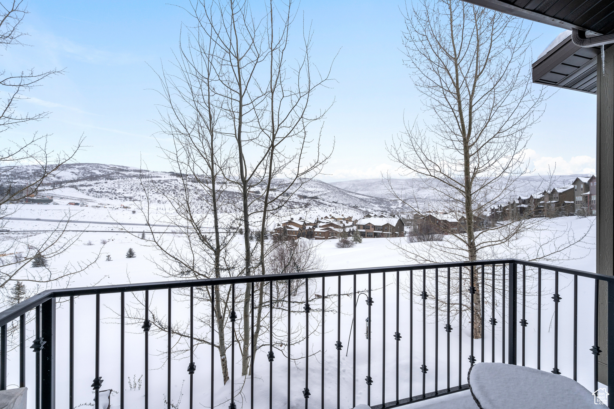 View of snow covered back of property