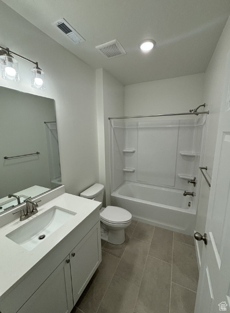 Full bathroom with shower / tub combination, tile floors, vanity, and toilet