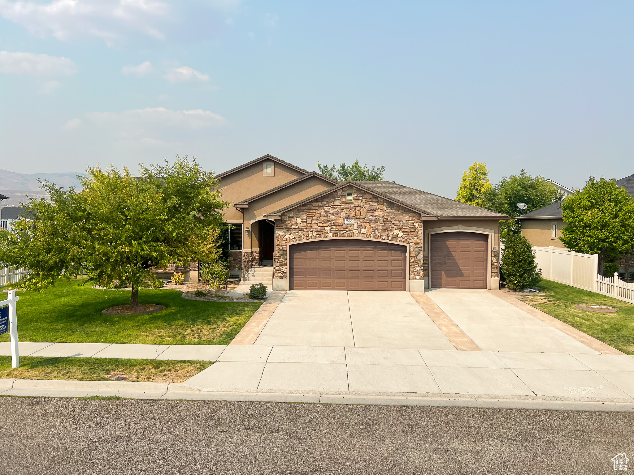 View of front facade with a garage and a front lawn