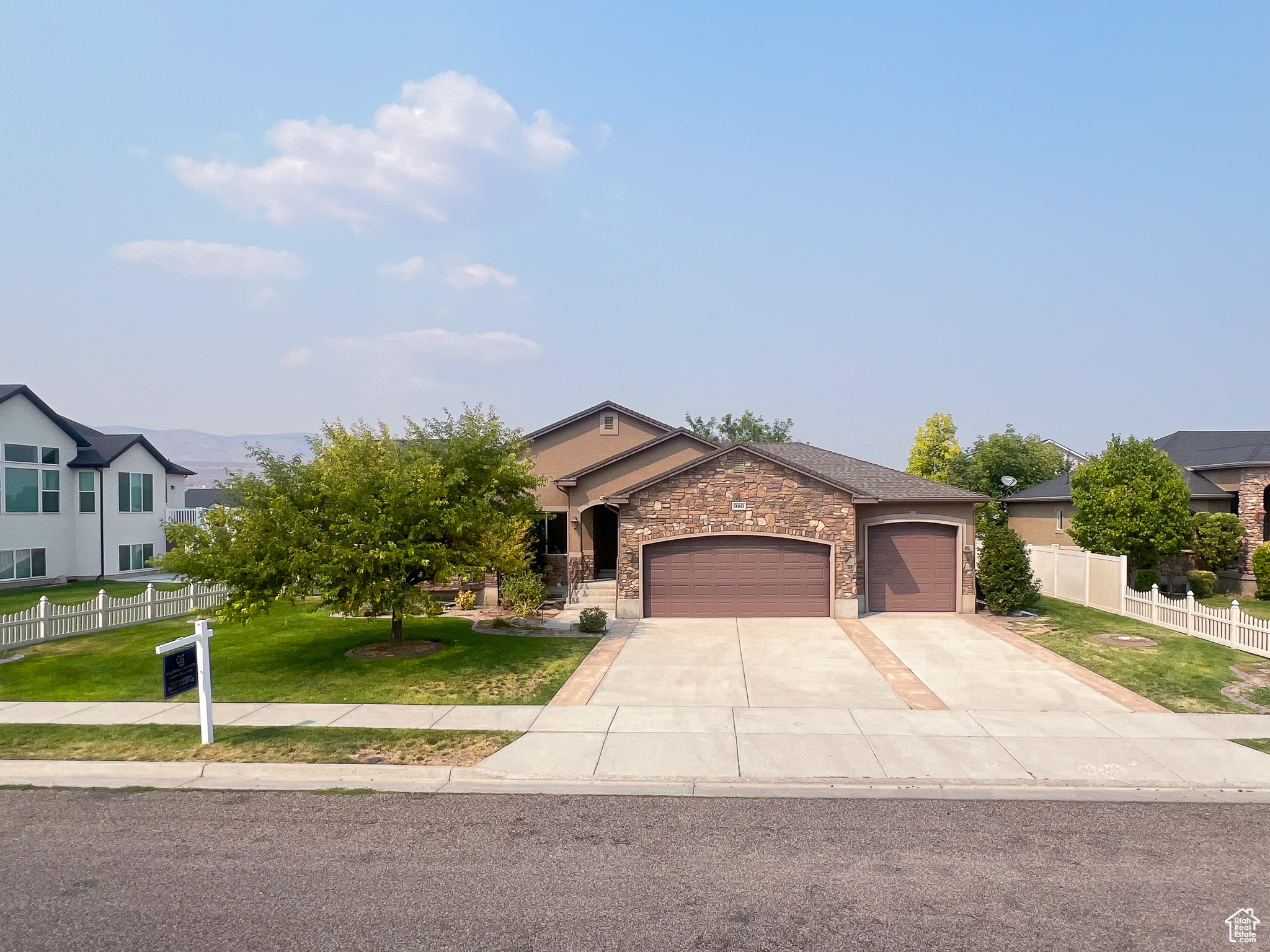 View of front of property featuring a garage and a front yard