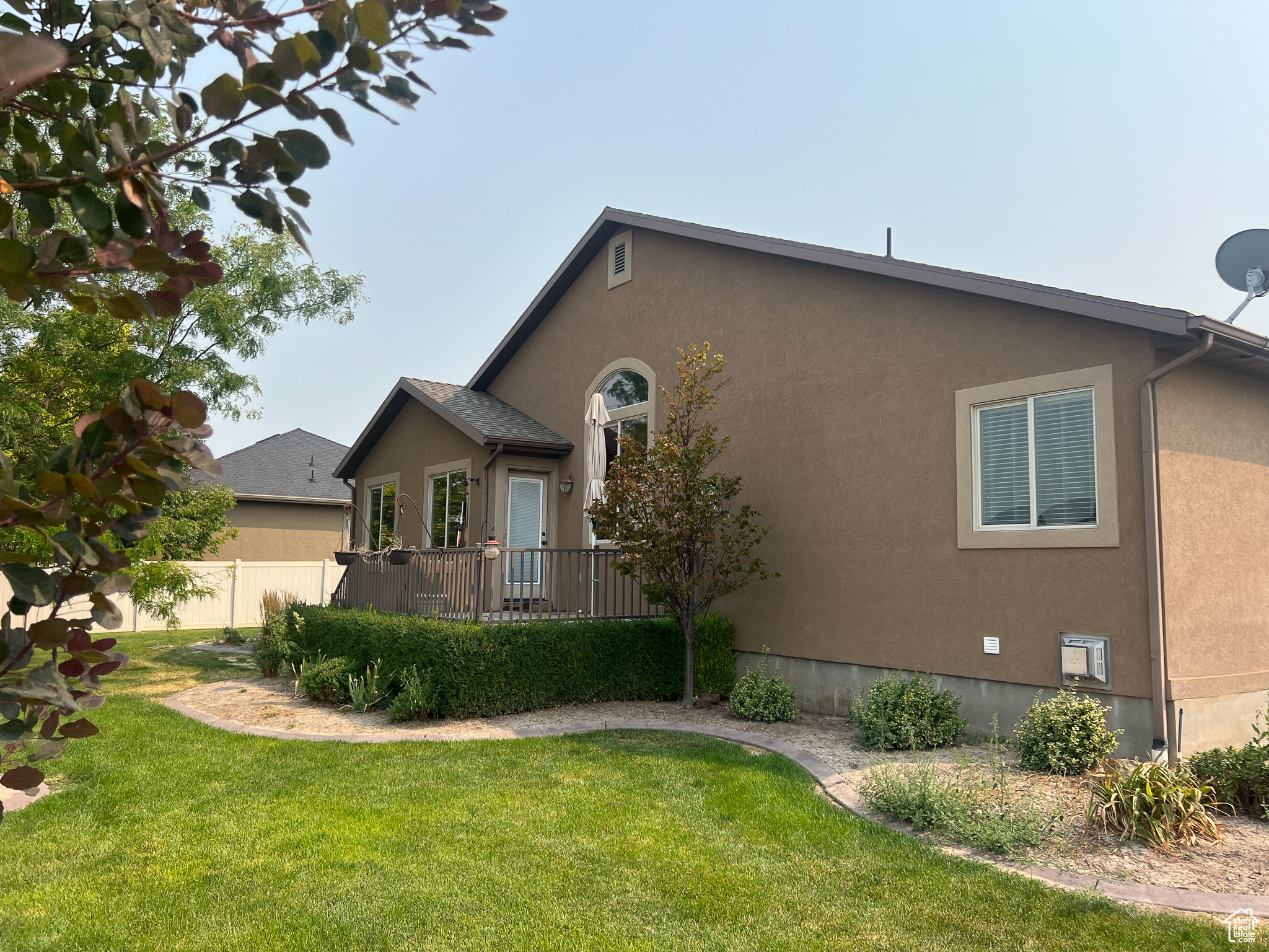 View of side of property with a lawn