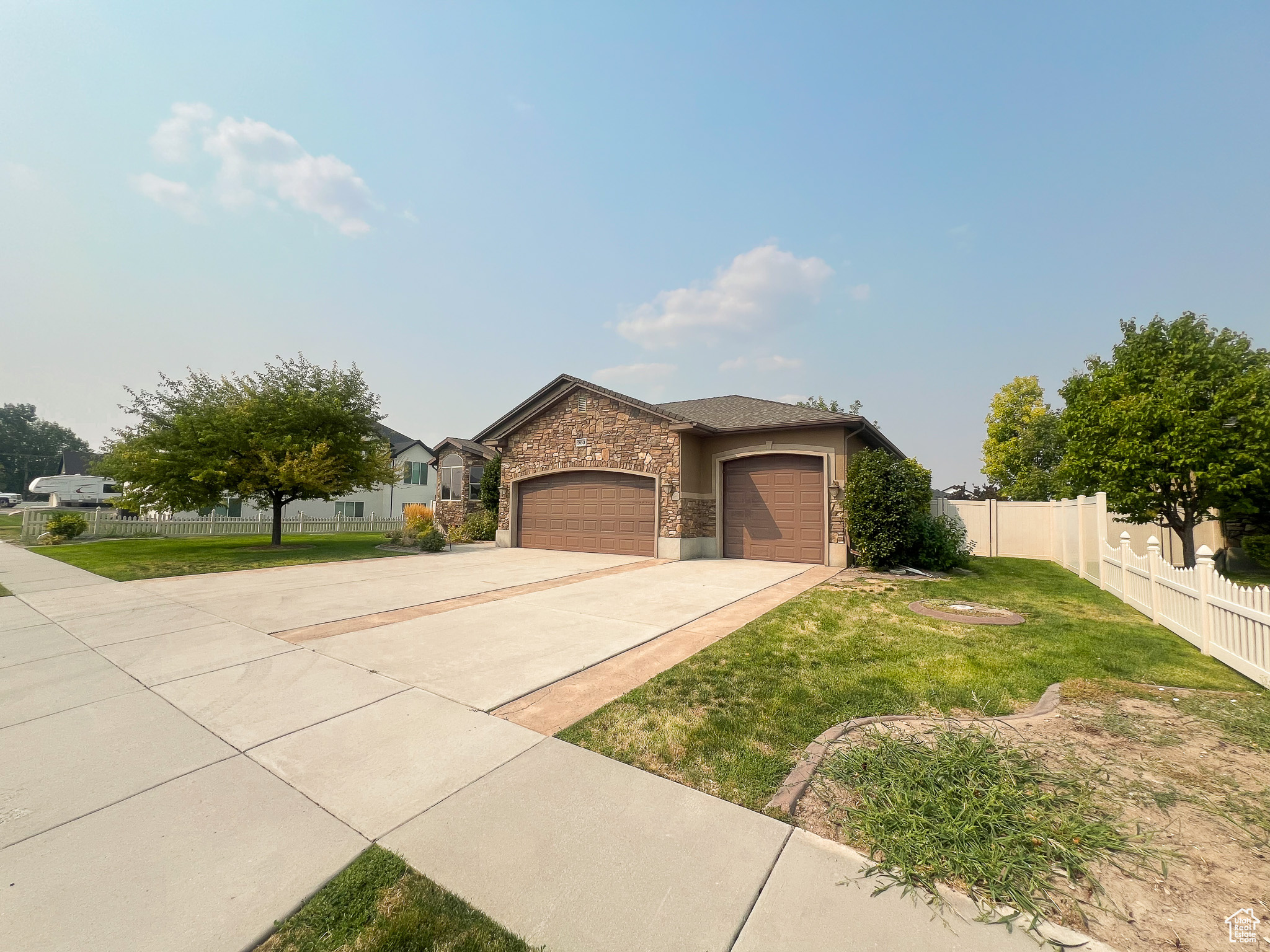 View of front of house with a garage and a front lawn