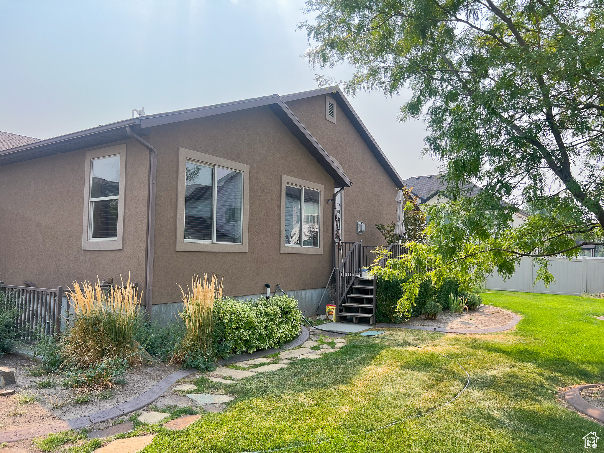 View of property exterior with a lawn