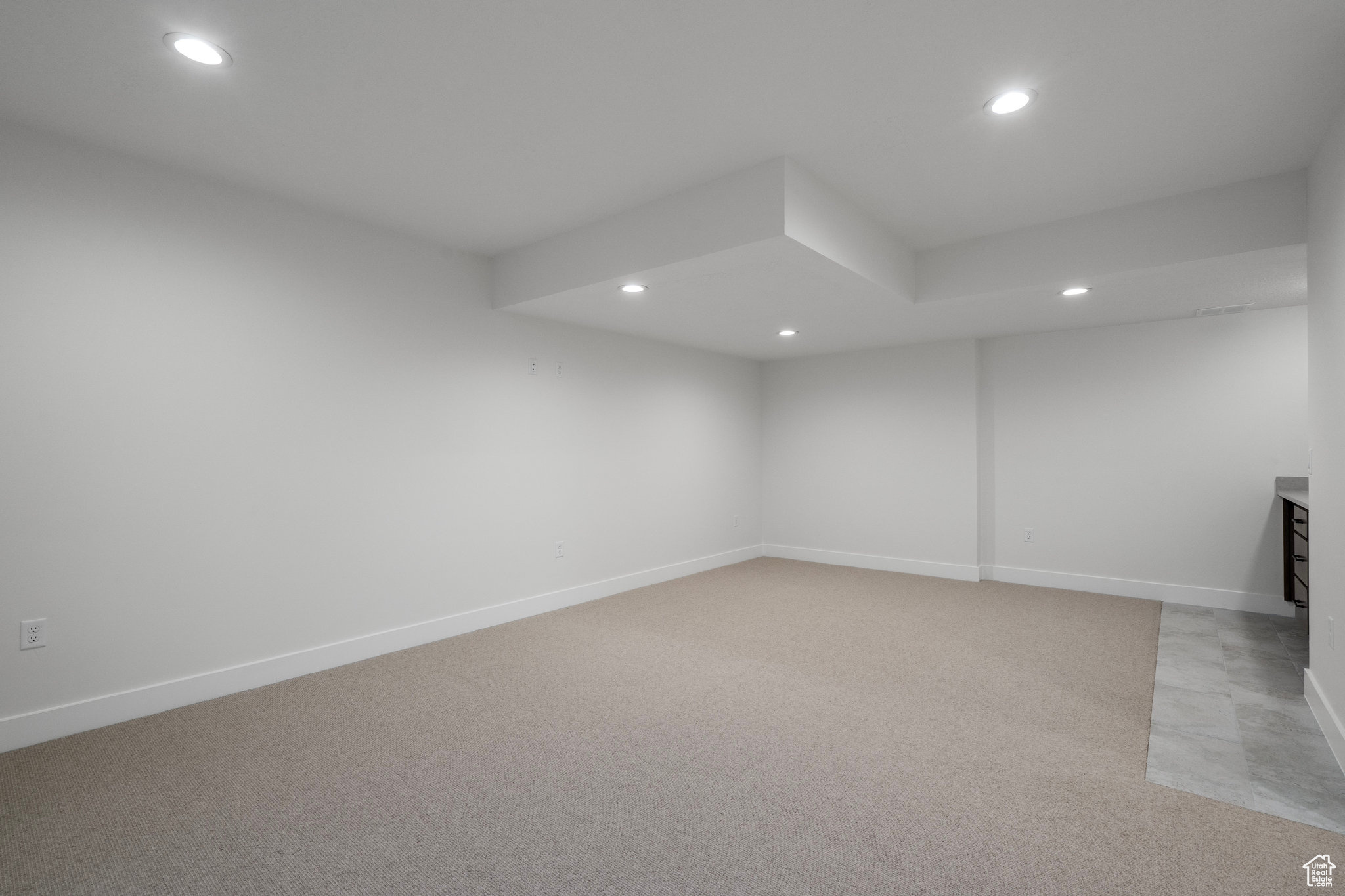 Unfurnished room with light colored carpet