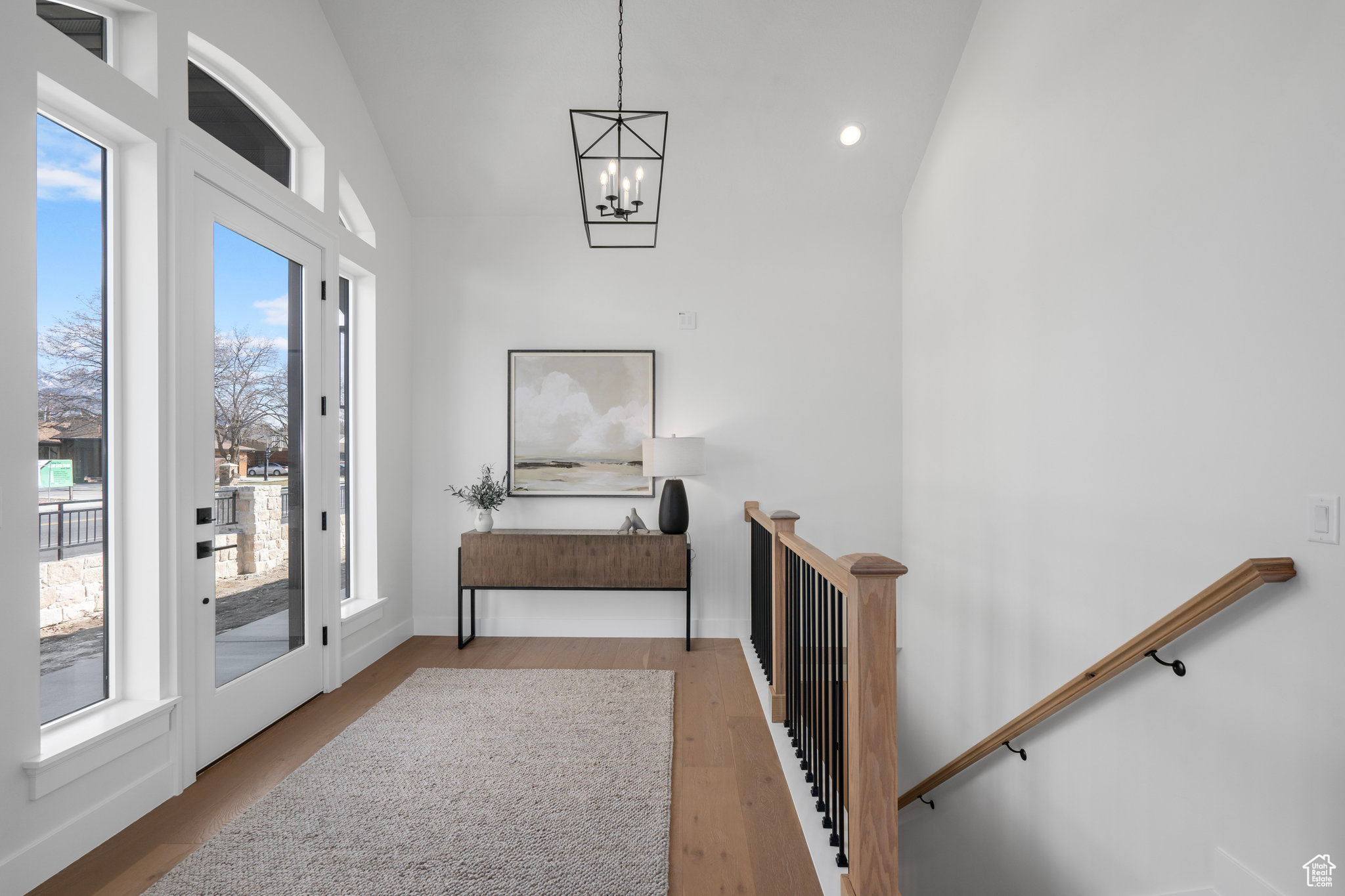 Interior space featuring a wealth of natural light, lofted ceiling, and light hardwood / wood-style floors