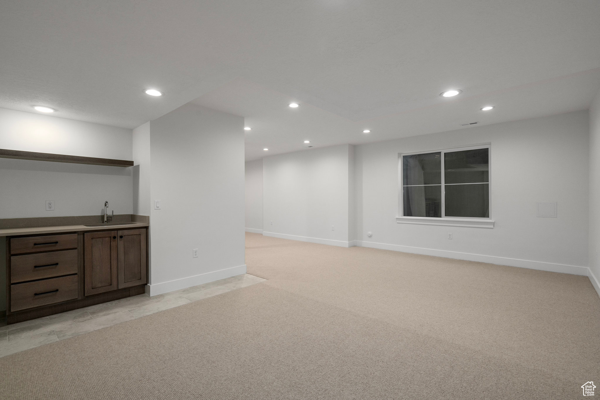 Interior space with light carpet and sink