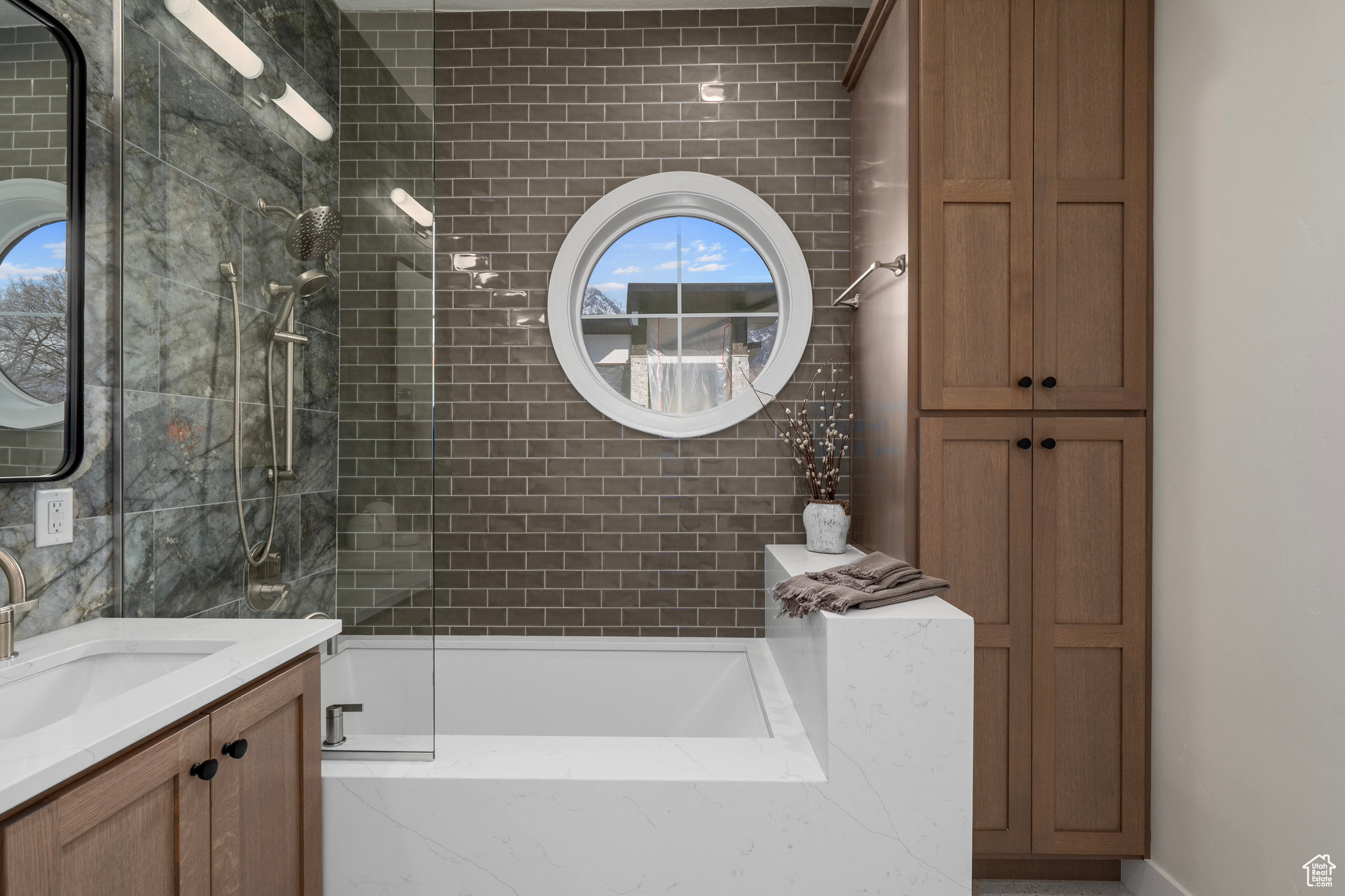 Bathroom with vanity and tile walls