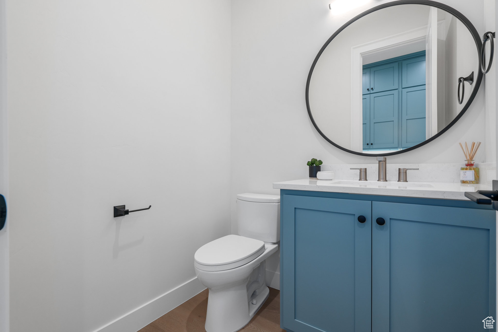 Bathroom with toilet, wood-type flooring, and oversized vanity