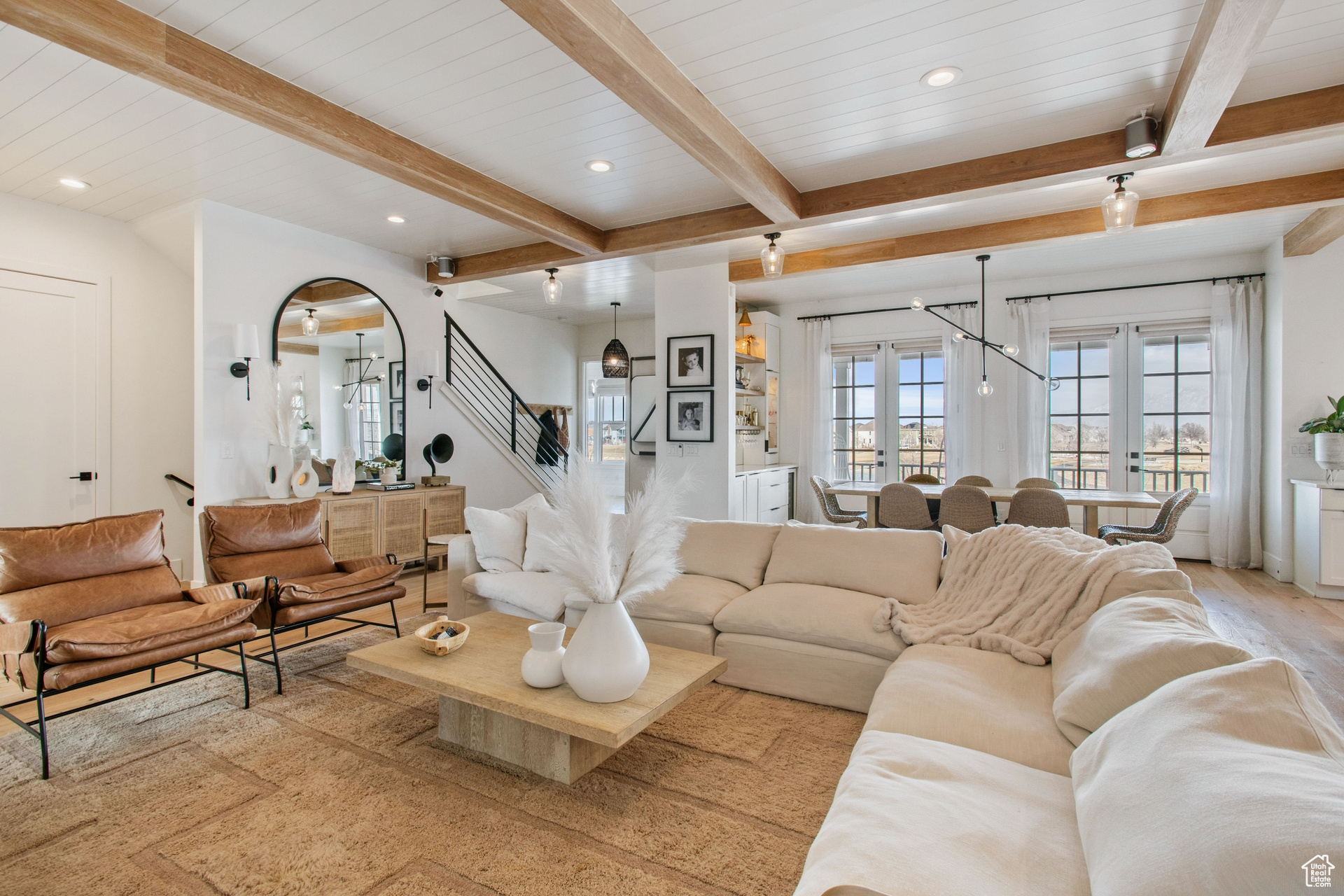 Living room with french doors, light hardwood / wood-style flooring, and beamed ceiling