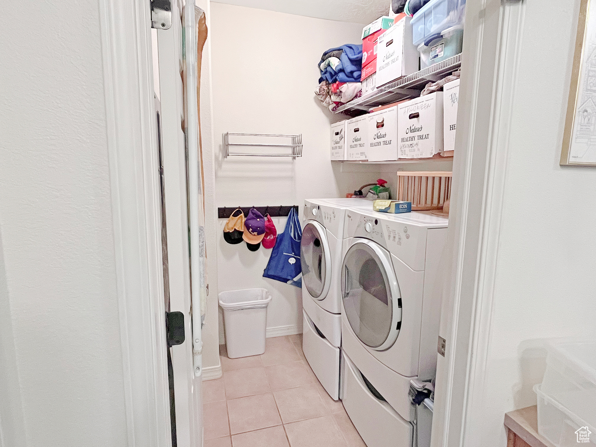 Washroom featuring a separate washer and dryer and easy storage