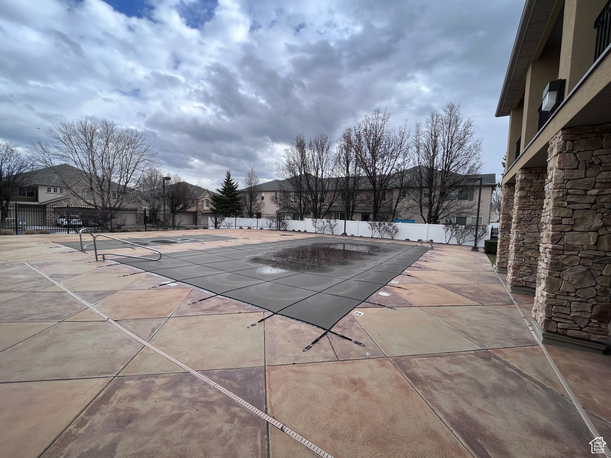 View of pool and hot tub featuring a patio area at the community center