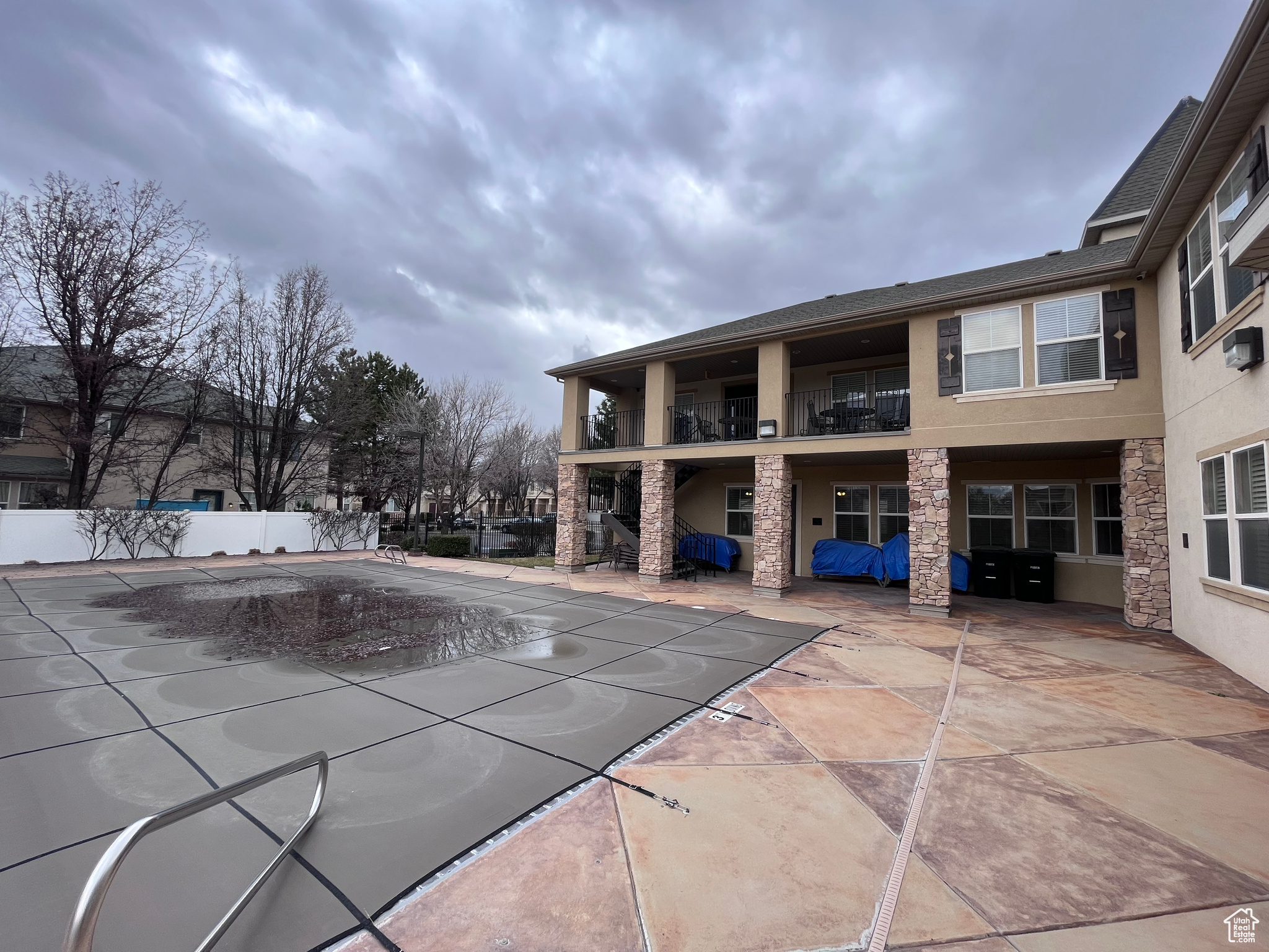 Exterior space with a swimming pool and a patio area at the community center