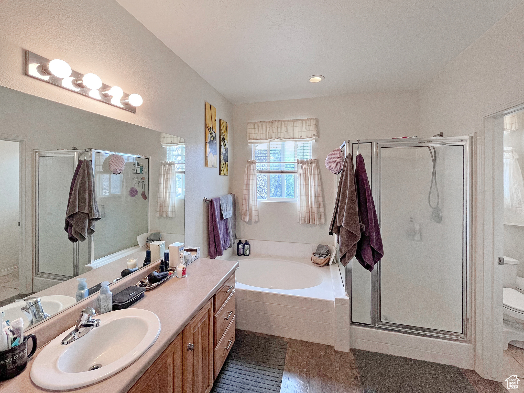 Master Full bathroom featuring a separate toilet room, large tub, plus a walk in shower
