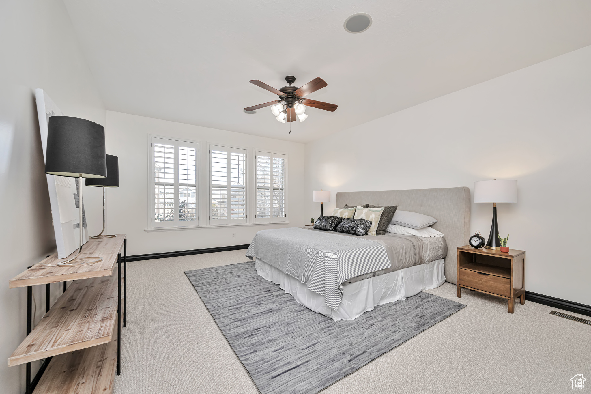 Large Principal Bedroom 1 featuring light colored carpet and ceiling fan