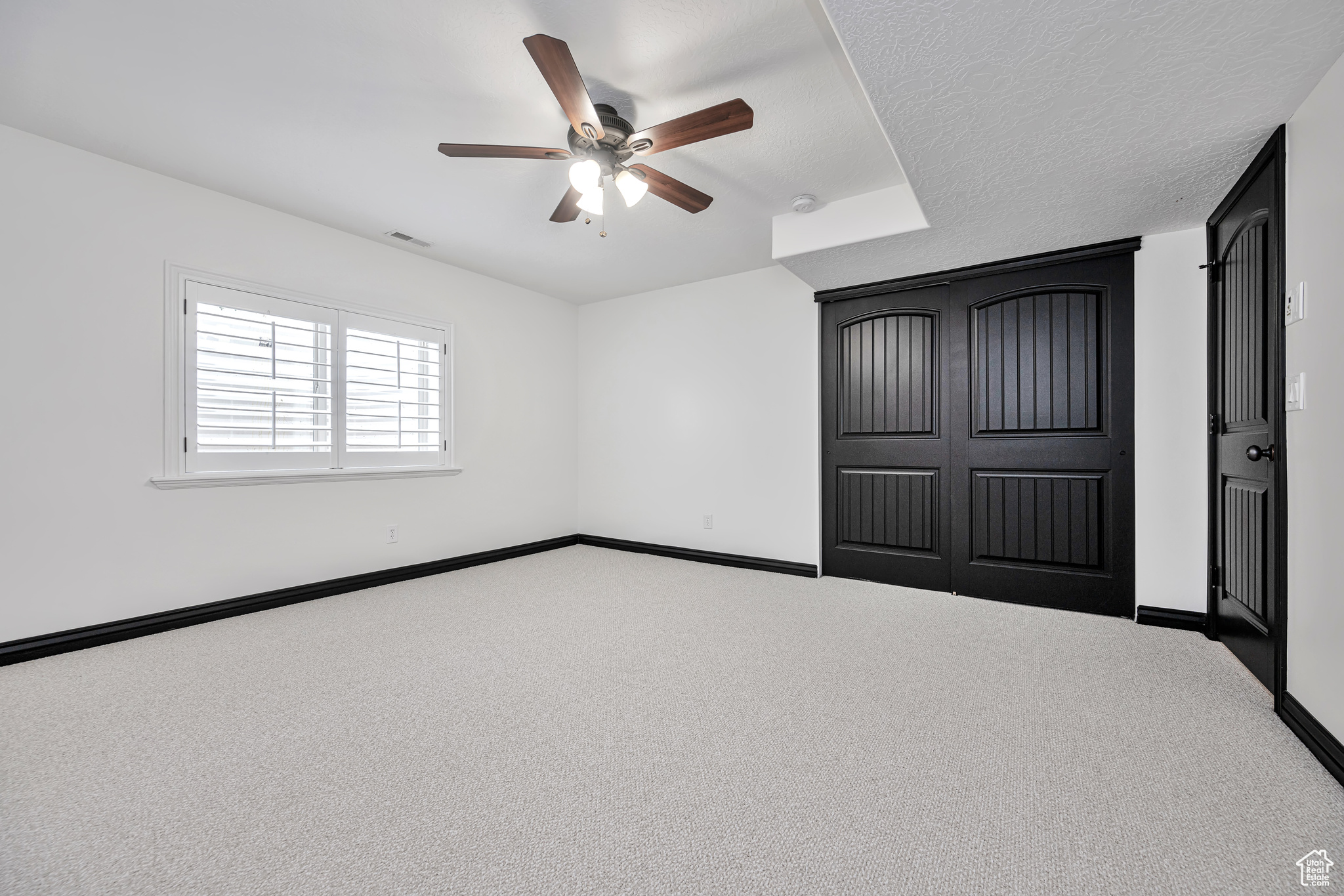 Bedroom 5 featuring carpet, a closet, and a ceiling fan