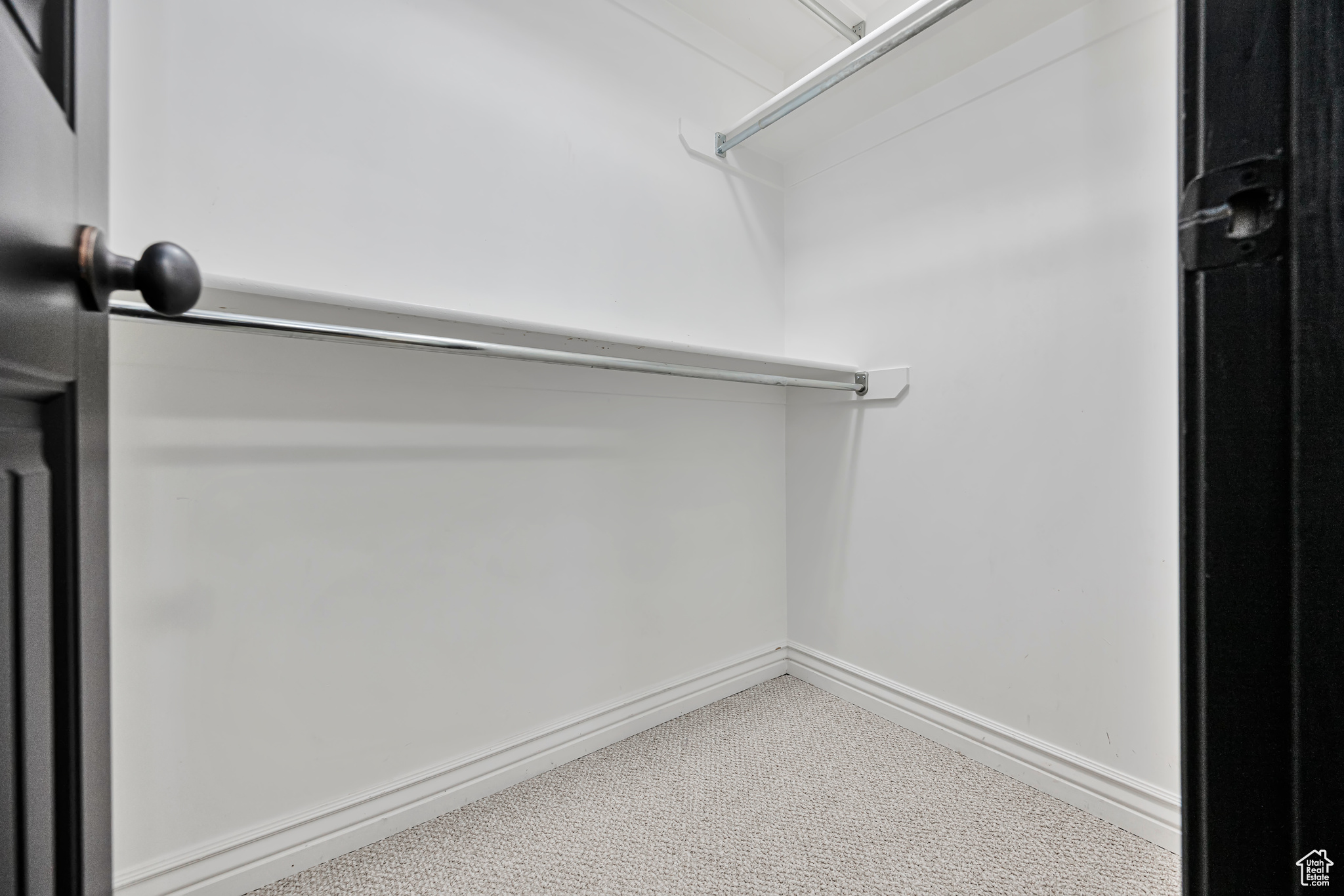 Spacious closet with light-colored carpet
