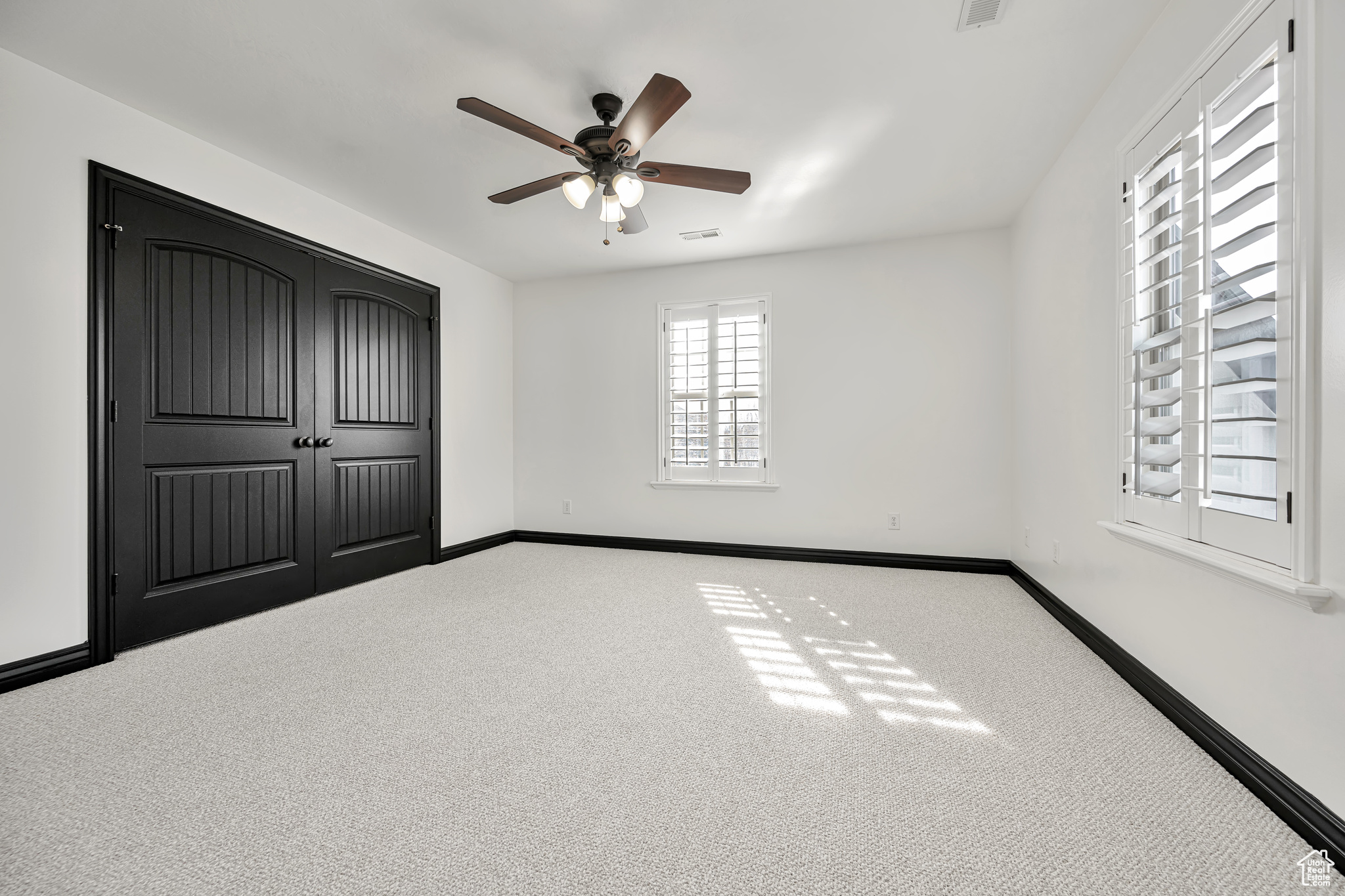 Bedroom 2 featuring light light-colored carpet and ceiling fan with a Jack/Jill bathroom