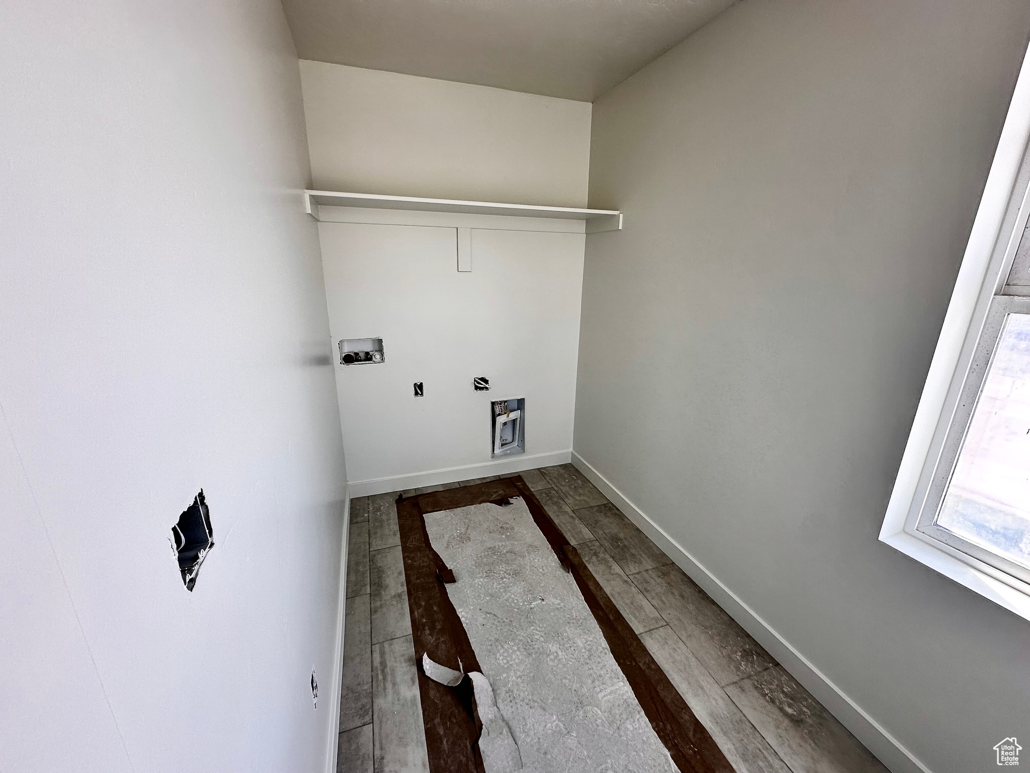 Laundry room with dark hardwood / wood-style flooring and washer hookup