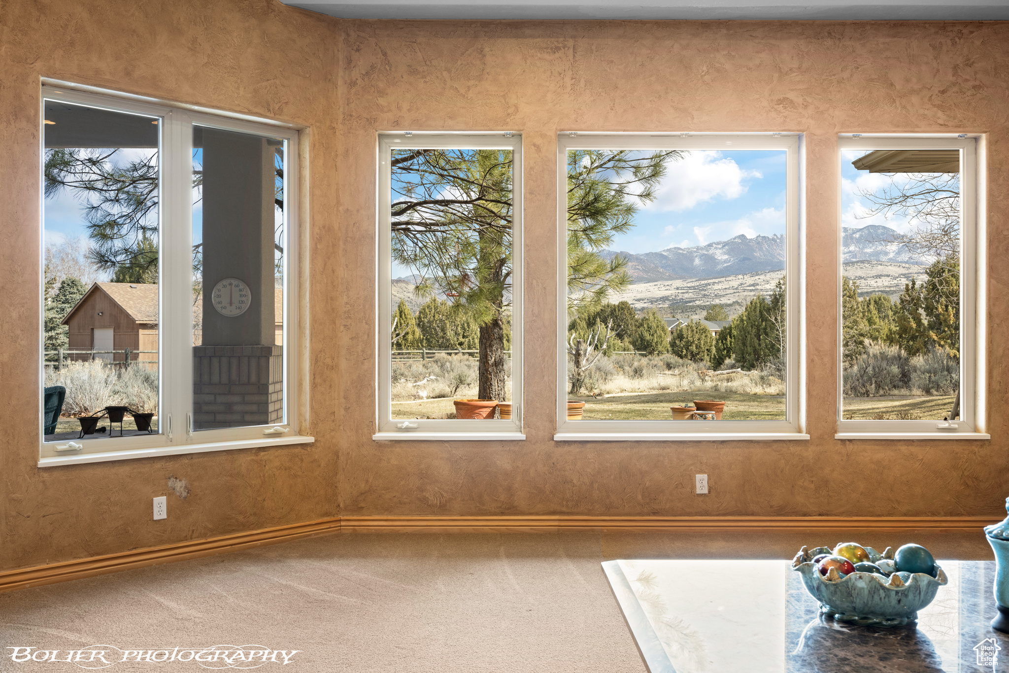 Unfurnished sunroom featuring a mountain view and a wealth of natural light