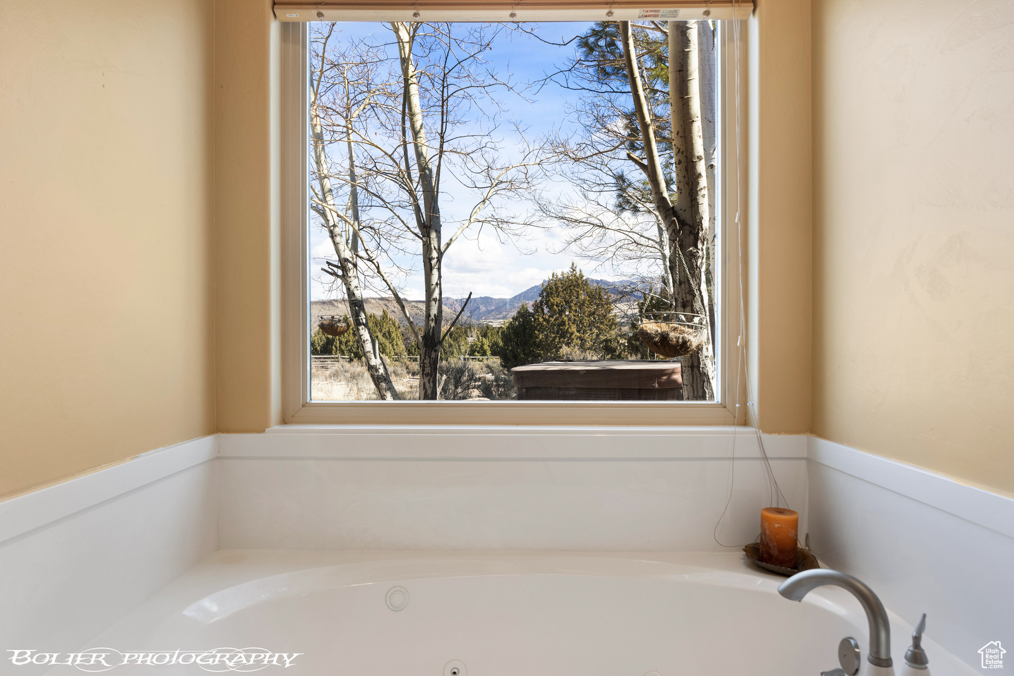 Bathroom featuring a mountain view and a bath to relax in