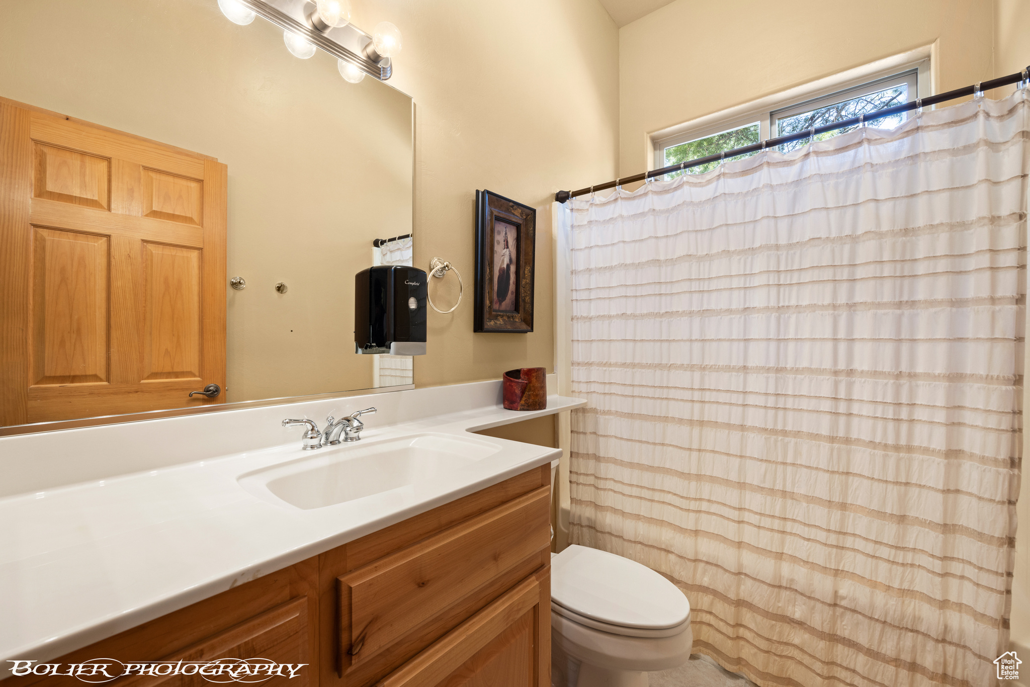 Bathroom featuring oversized vanity and toilet