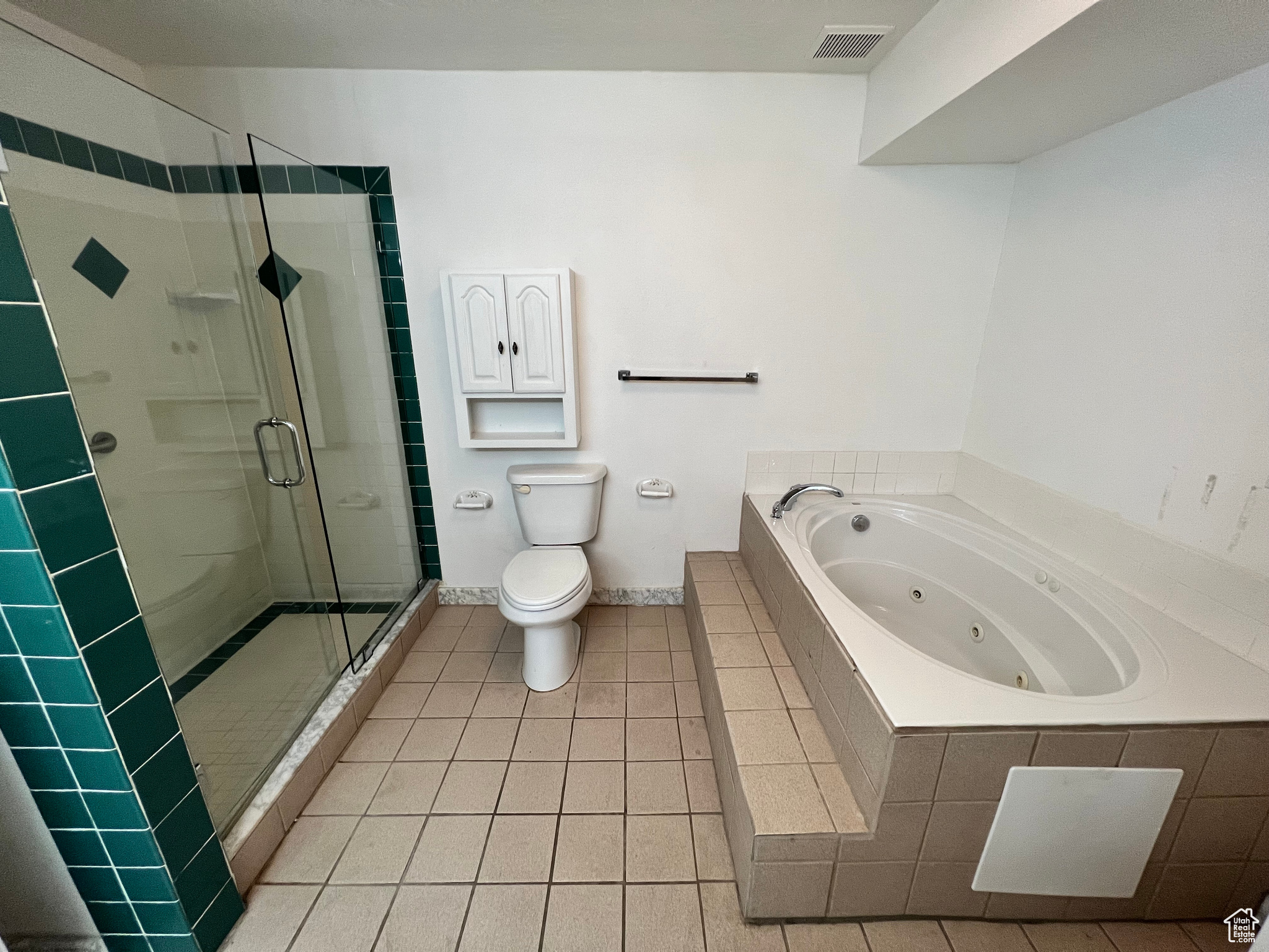 Bathroom with shower with separate bathtub, toilet, and tile flooring