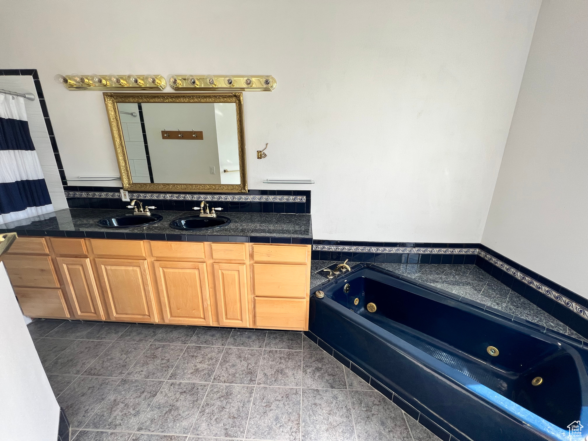 Bathroom featuring tile flooring and dual bowl vanity