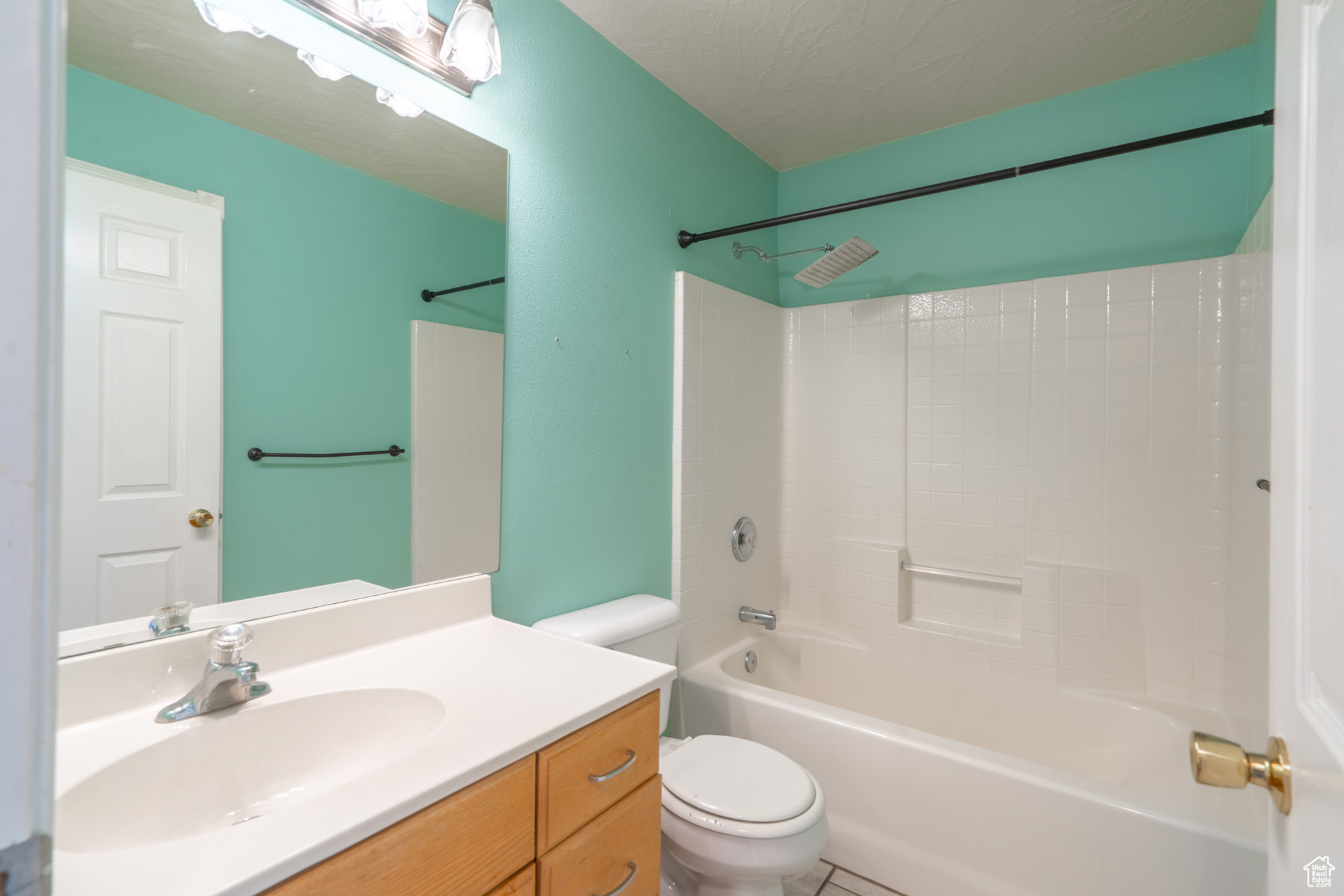 Full bathroom featuring tub / shower combination, tile floors, toilet, and vanity