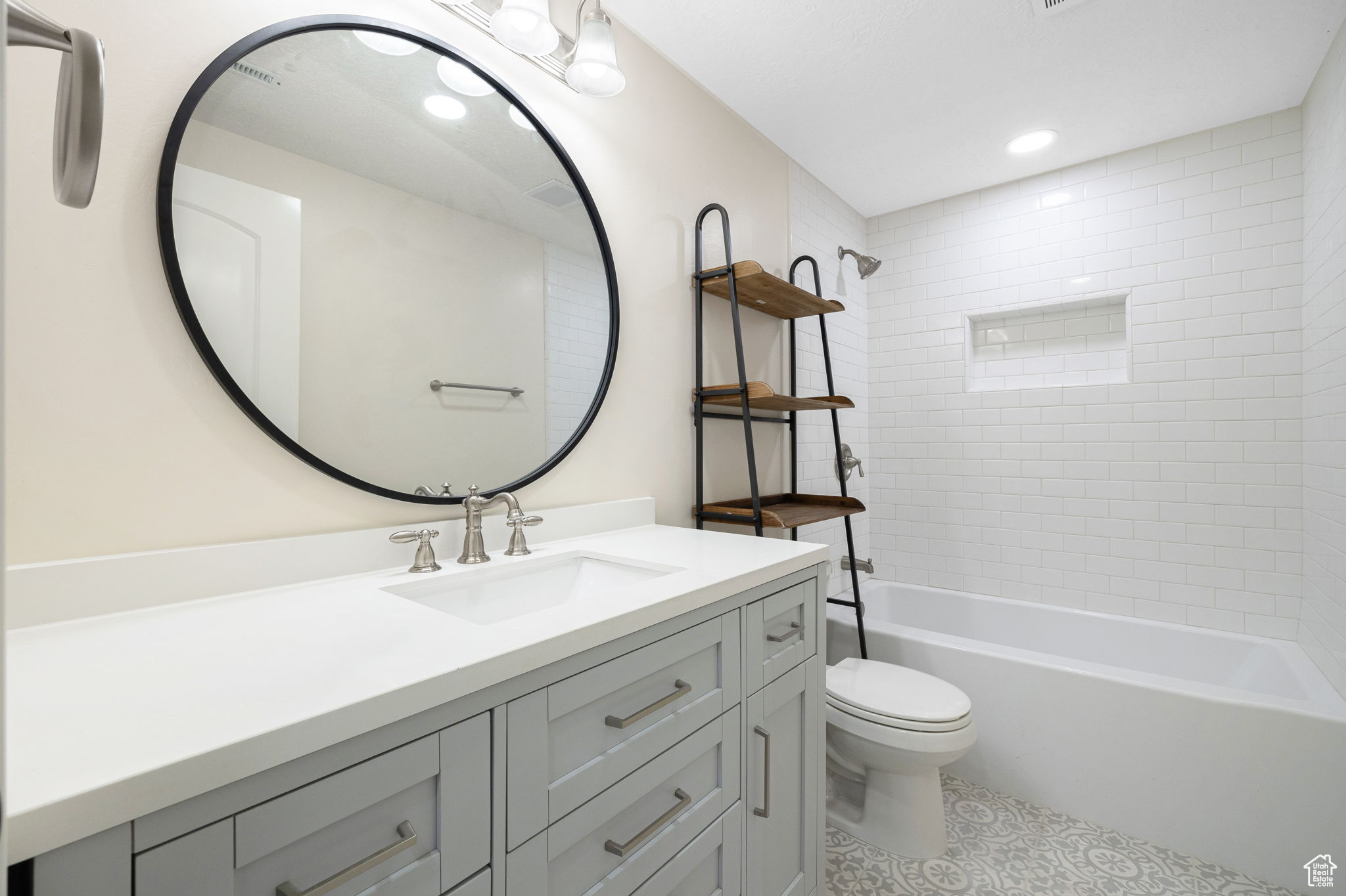 Basement apatment / flex area - Full bathroom featuring tiled shower / bath combo, vanity, tile flooring, and toilet