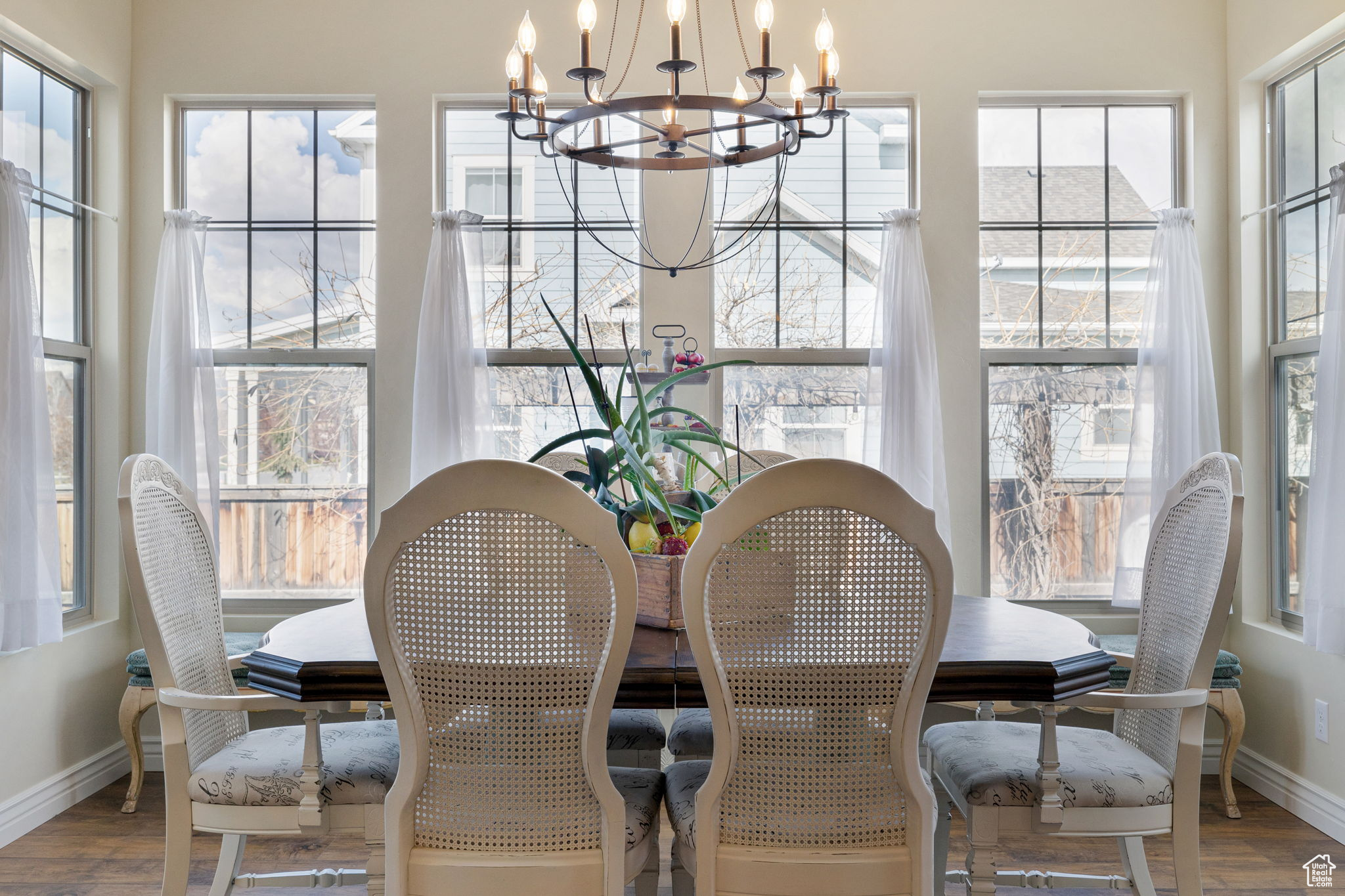Dining area featuring a healthy amount of sunlight, a chandelier, and hardwood / wood-style flooring