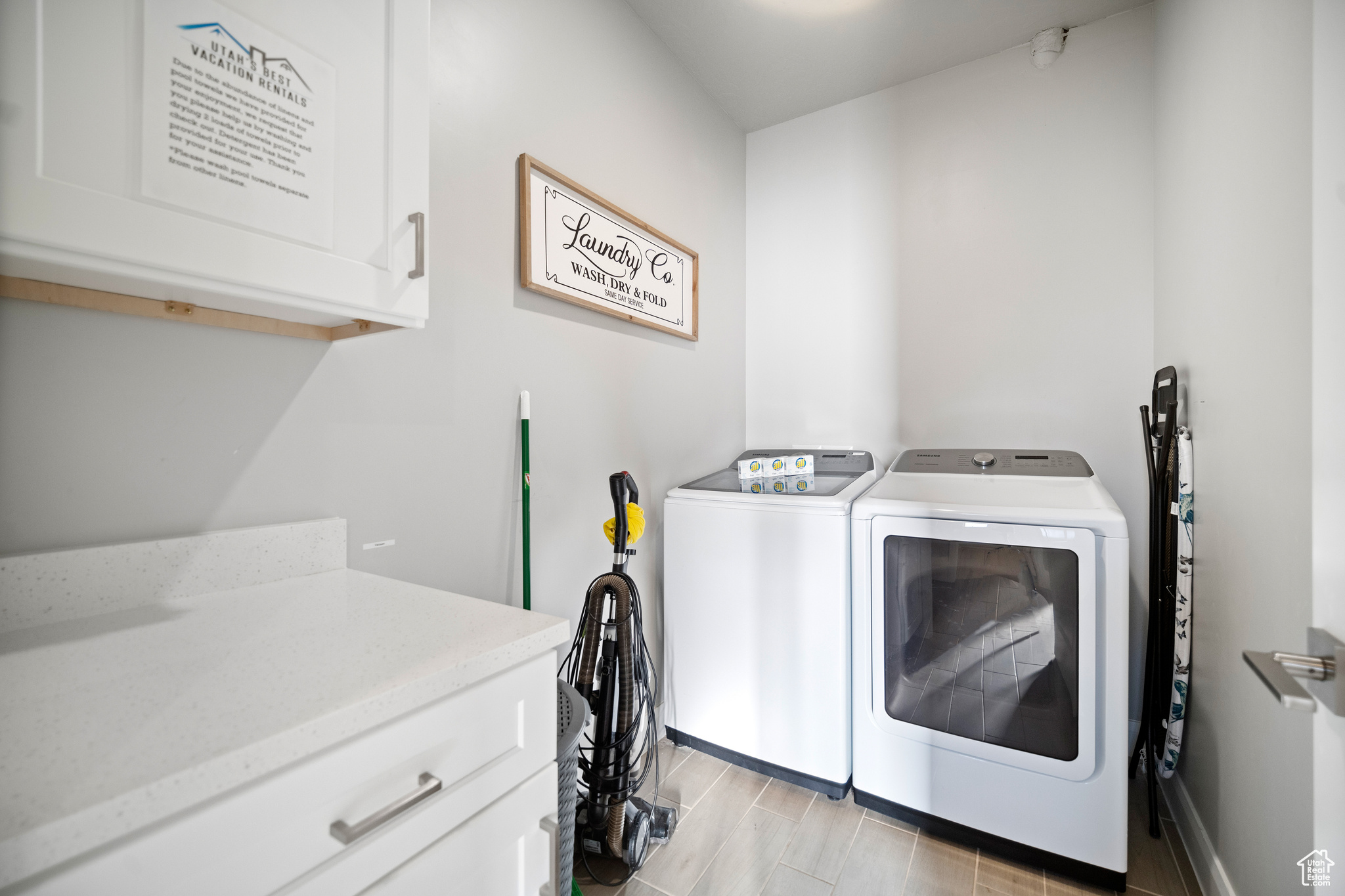 Large laundry room with Samsung washer and dryer.