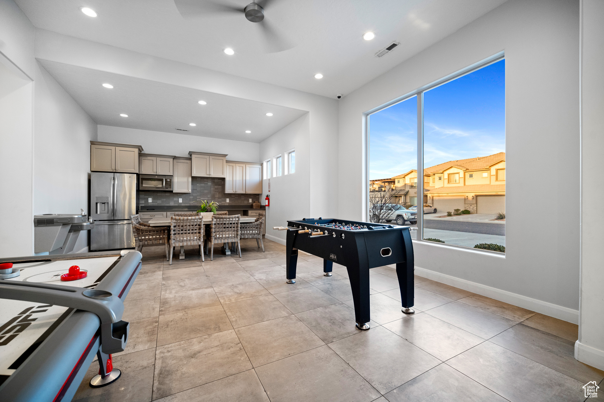 Game room with light tile floors and ceiling fan