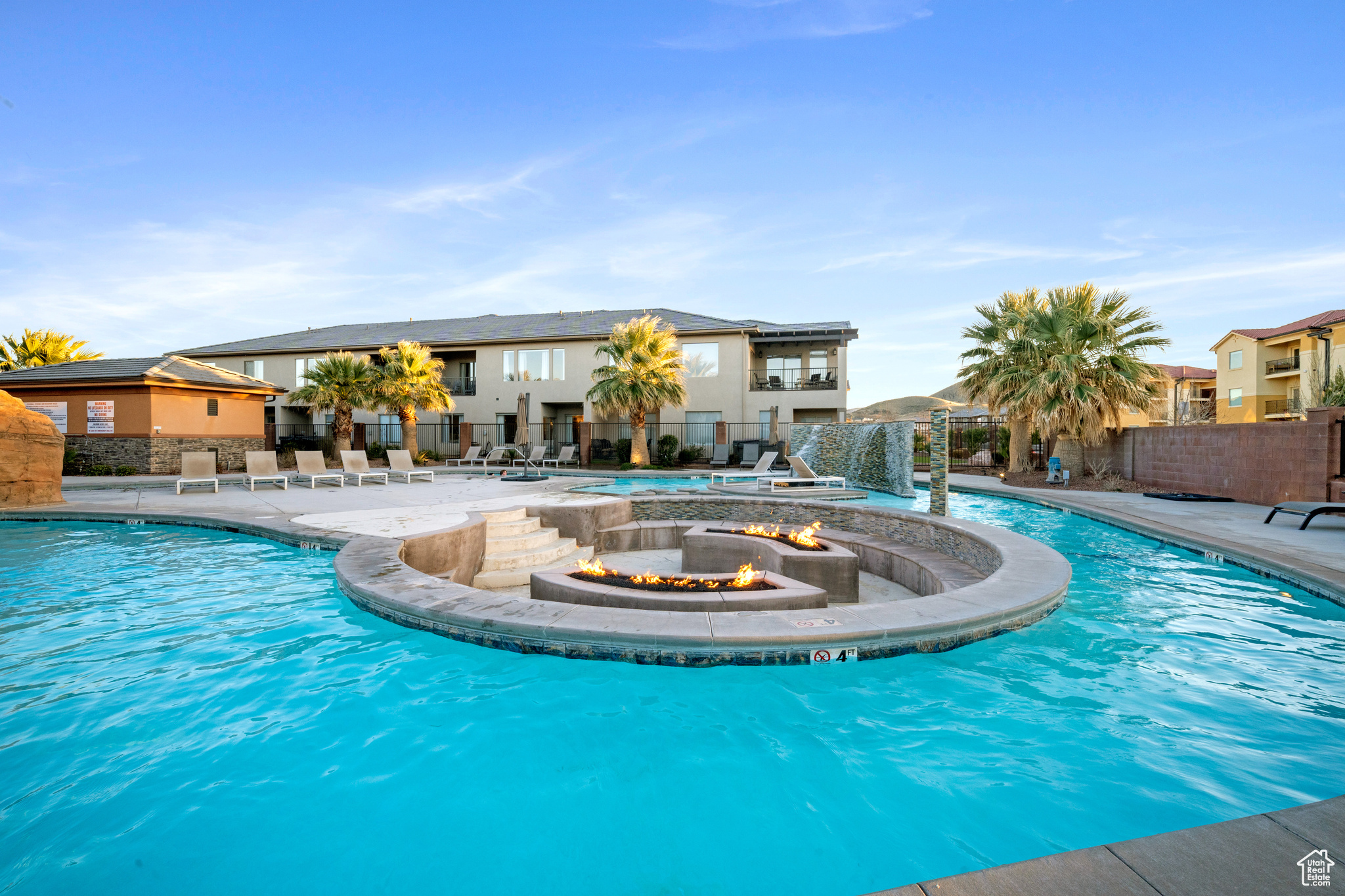 View of swimming pool featuring a fire pit and a patio. Clubhouse pool.