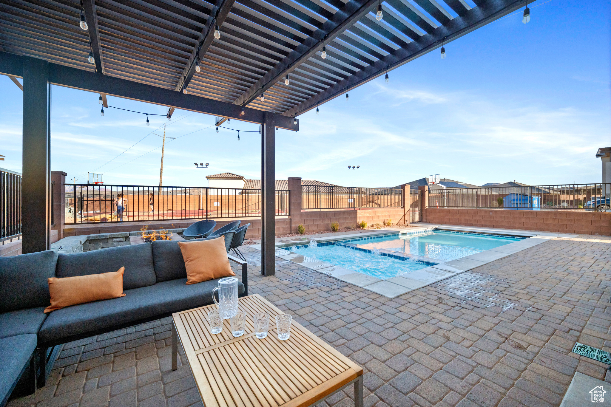 View of swimming pool with a patio area, an outdoor hot tub, and a pergola. No backyard neighbors.