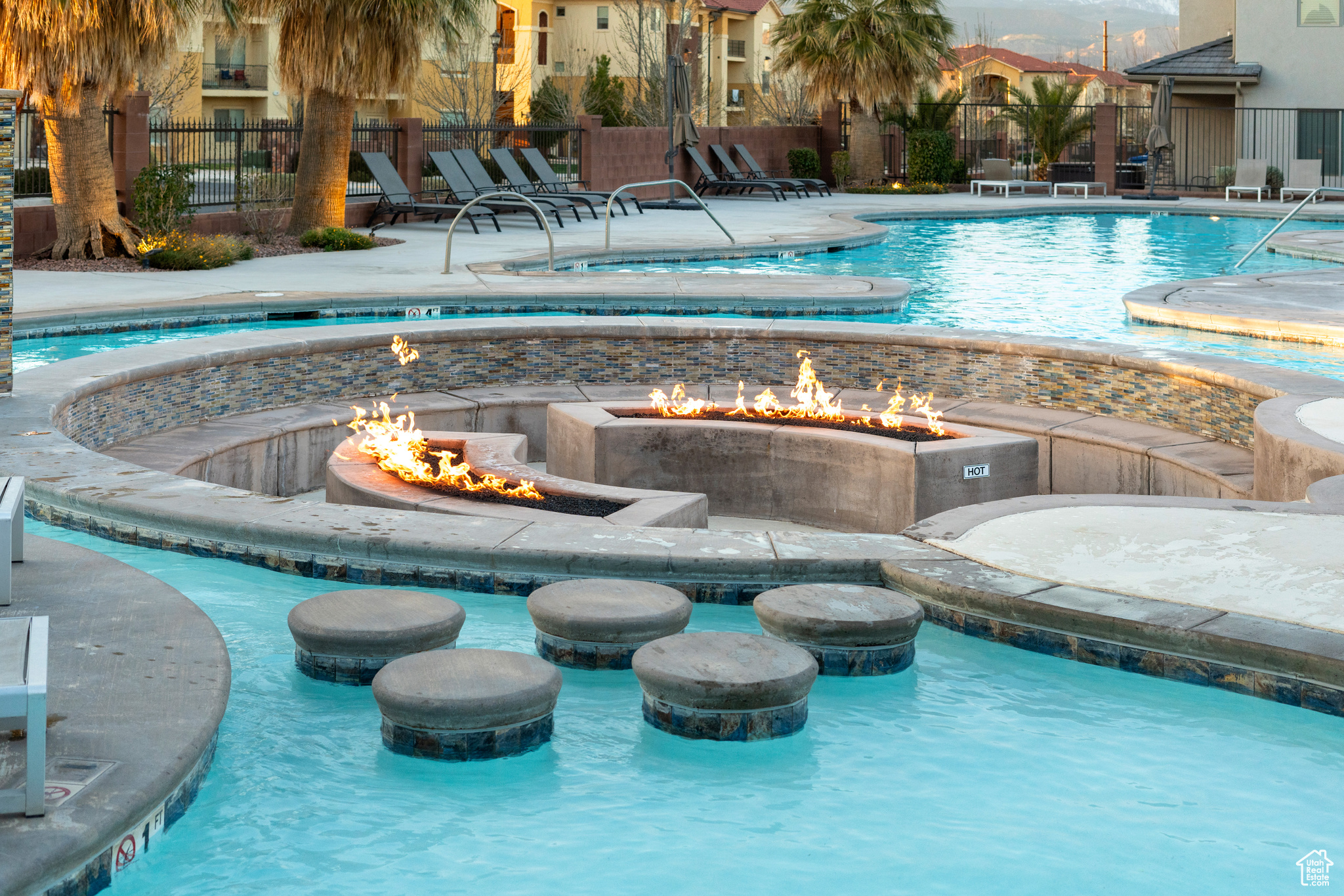 View of swimming pool featuring an outdoor fire pit.Lazy river.