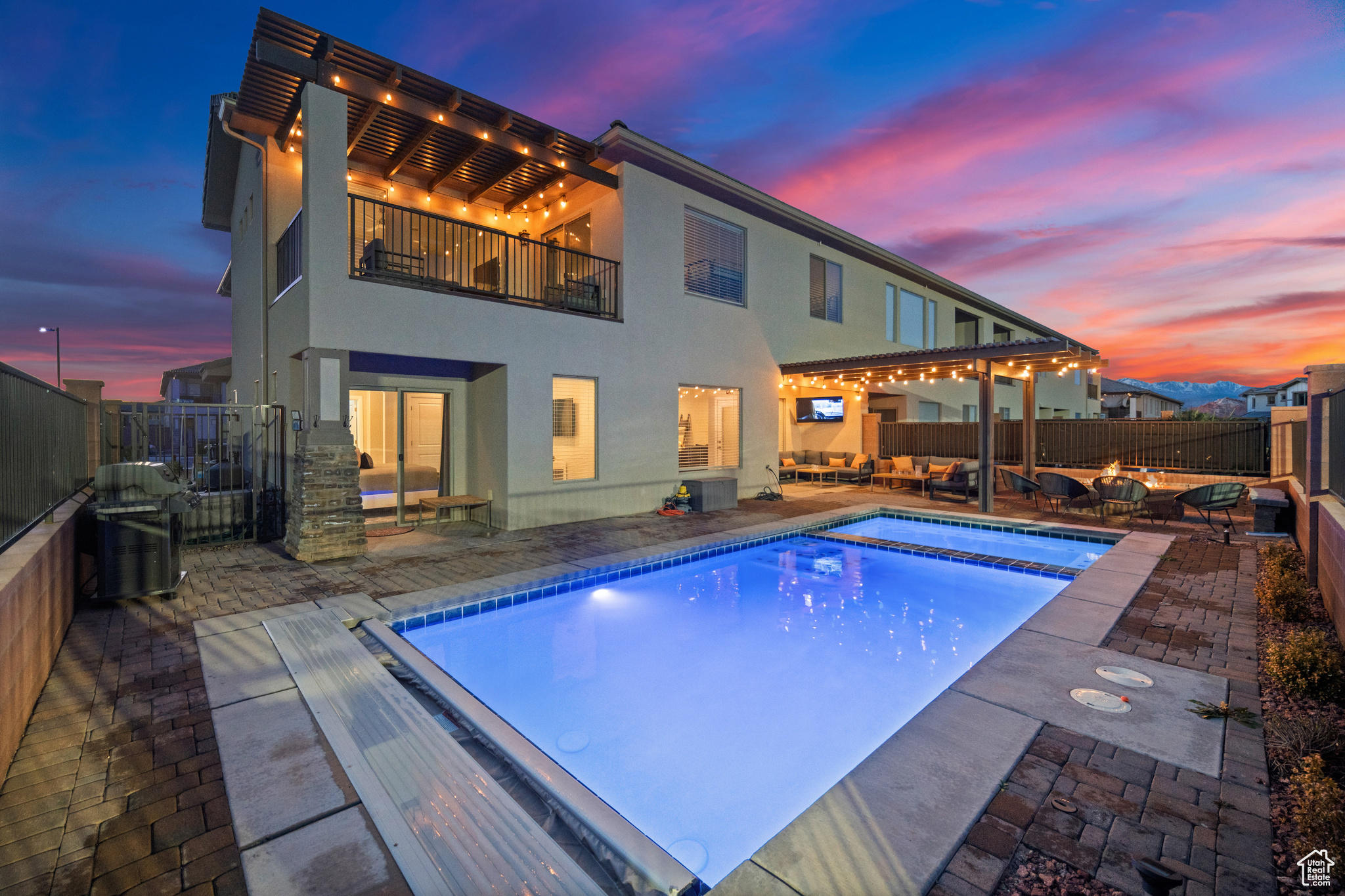 Backyard with private pool, hot tub and lounge area with fire pit.