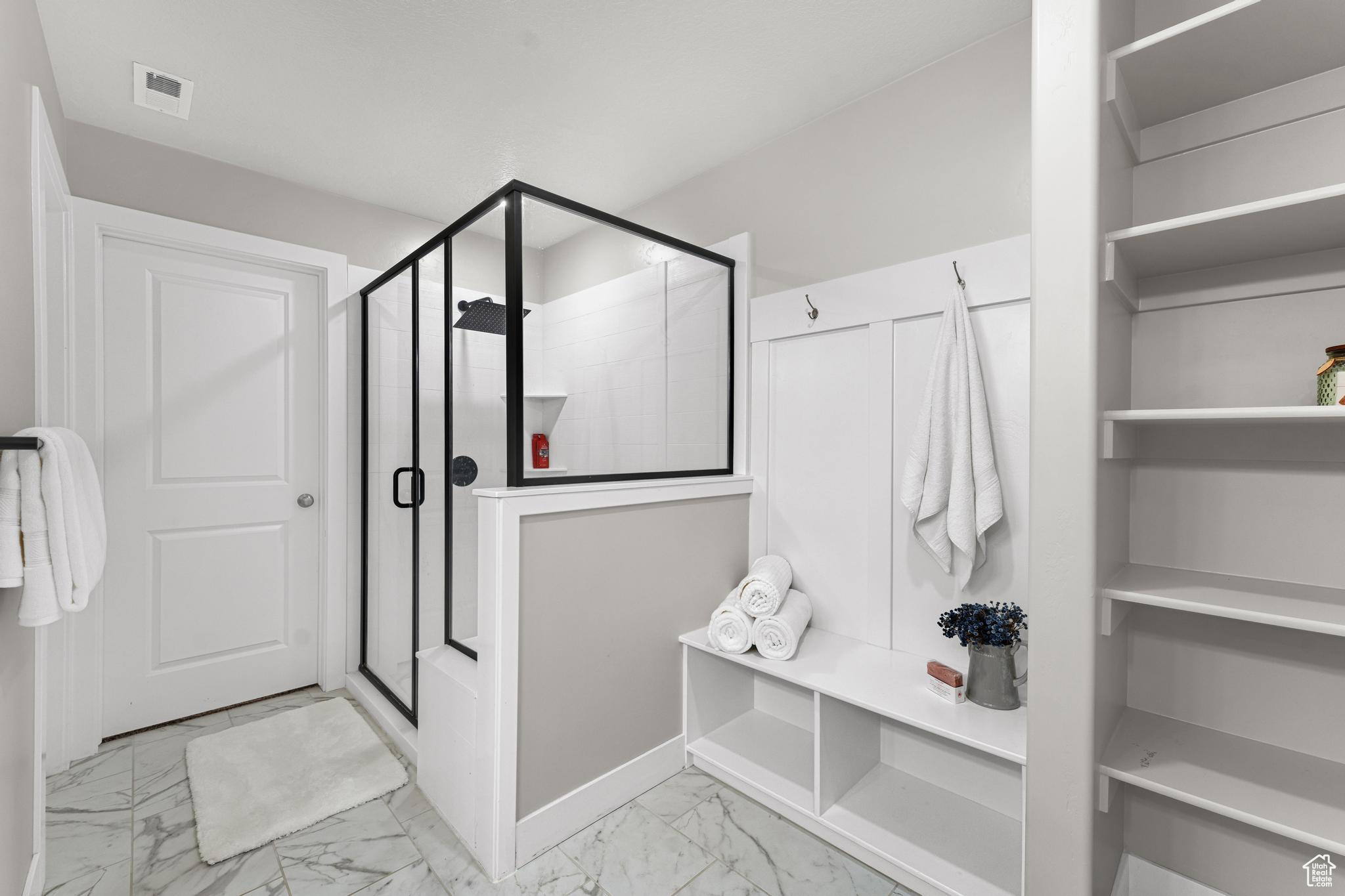 Upstairs Owner's Suite Bathroom Featuring Ample Storage, Two-Tone Paint, and Luxurious Oversized Shower