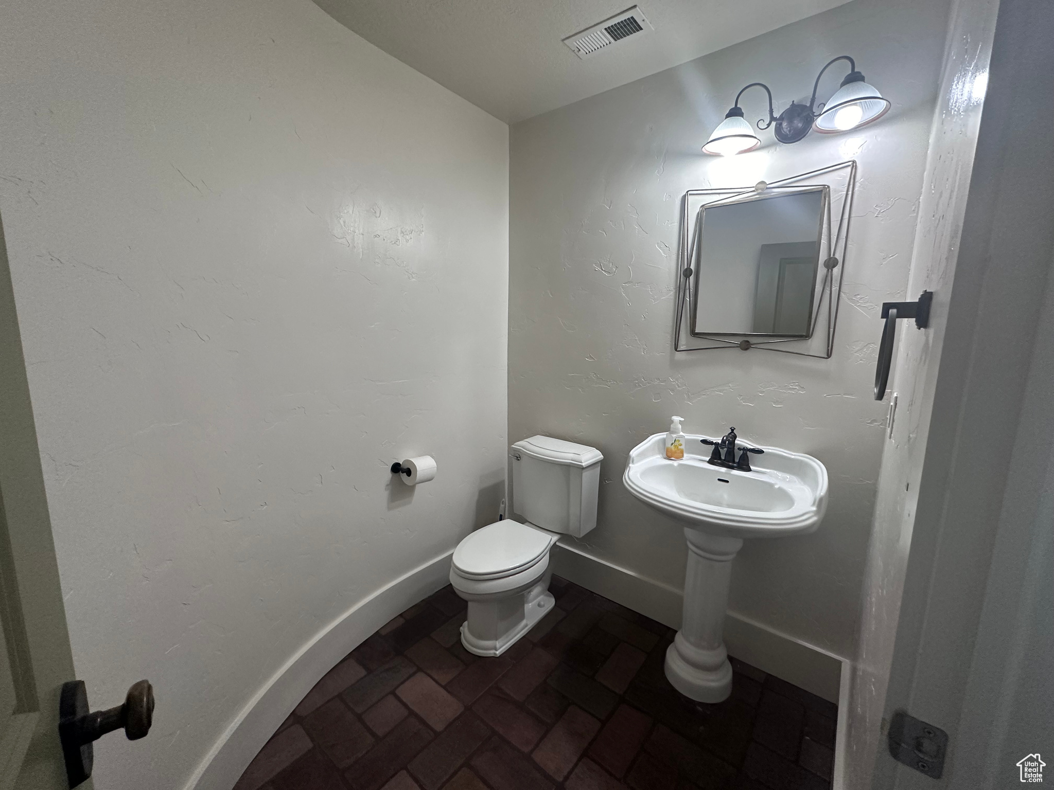 Large Half Bathroom featuring toilet